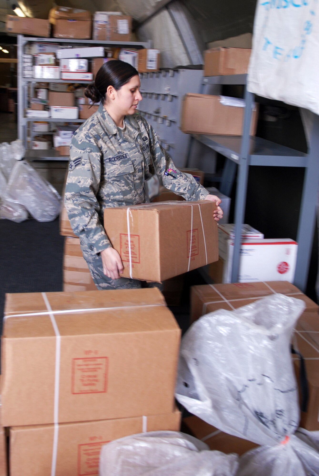 Senior Airman Yolanda Rodriguez volunteers to sort mail Nov. 18 at Manas Air Base Kyrgyzstan. Between Thanksgiving and the first week of January, the Manas AB Post Office will receive roughly 4,400 pounds of mail every other day until the end of the holiday season. Airman Rodriguez is assigned to the 376th Expeditionary Force Support Squadron. (U.S. Air Force photo/Senior Airman Ruth Holcomb) 
