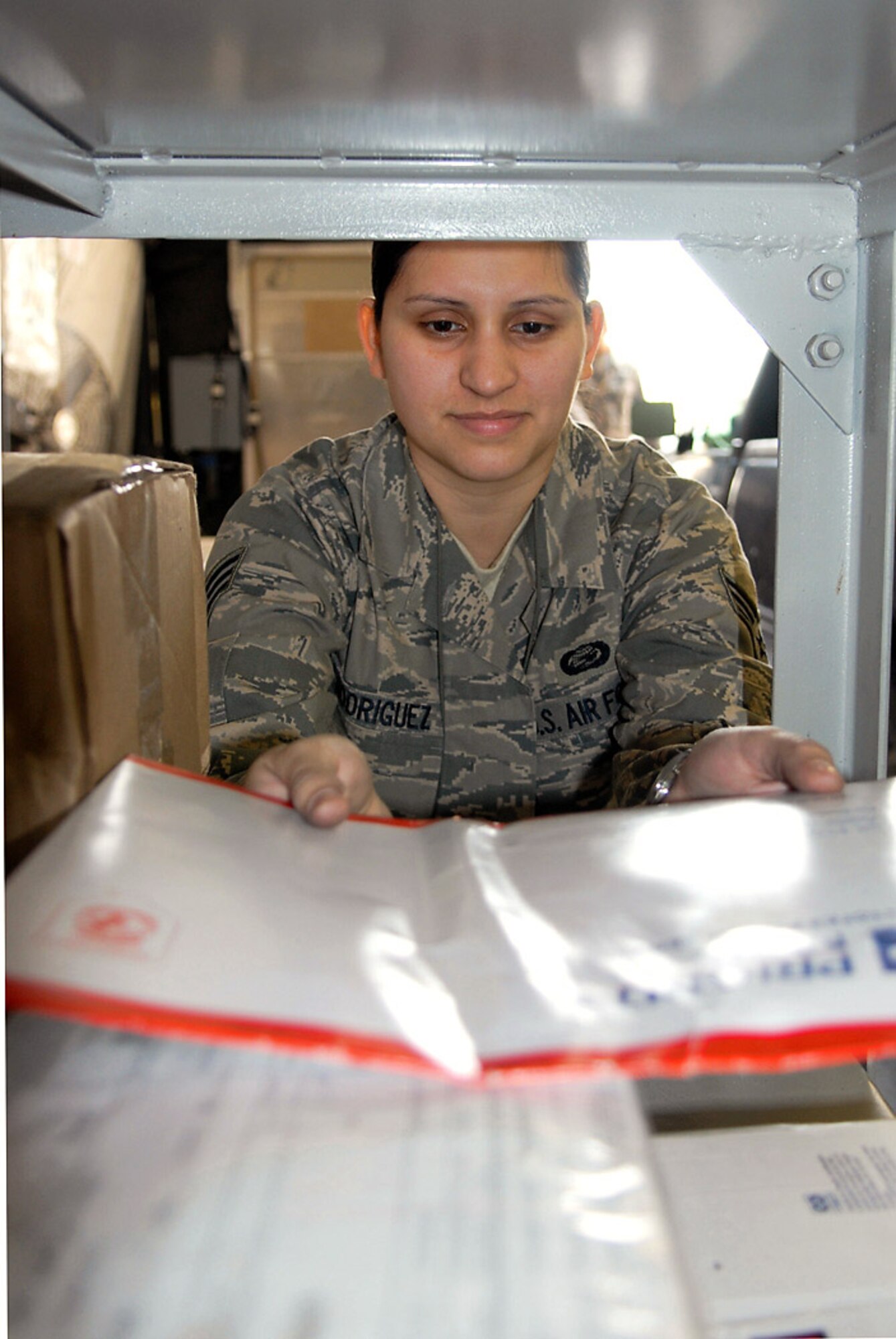 Senior Airman Yolanda Rodriguez volunteers to sort mail Nov. 18 at Manas Air Base Kyrgyzstan. Between Thanksgiving and the first week of January, the Manas AB Post Office will receive roughly 4,400 pounds of mail every other day until the end of the holiday season. Airman Rodriguez is assigned to the 376th Expeditionary Force Support Squadron. (U.S. Air Force photo/Senior Airman Ruth Holcomb) 
