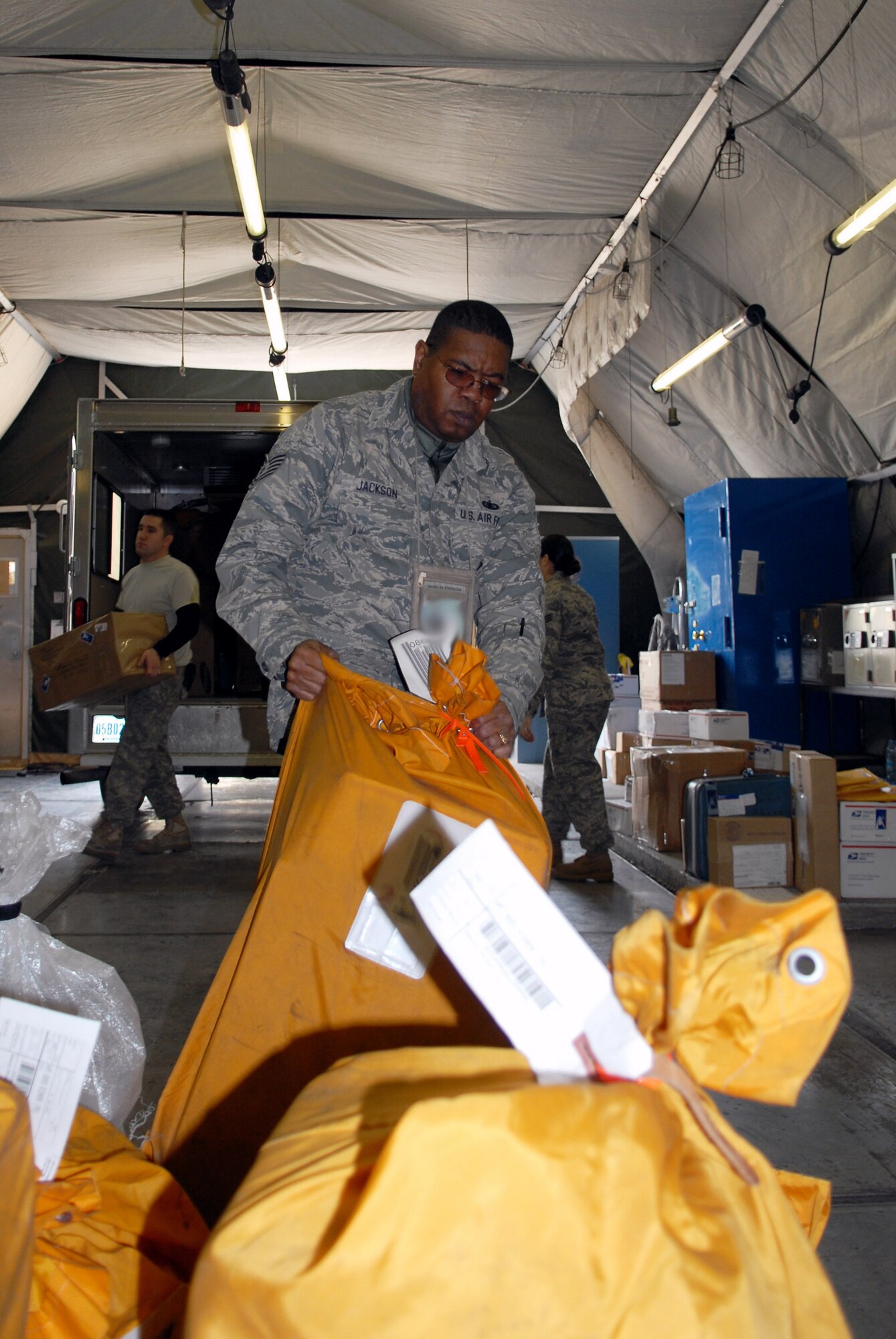 Tech. Sgt. Nelson Jackson volunteers to sort mail Nov. 18 at Manas Air Base Kyrgyzstan. Between Thanksgiving and the first week of January, the Manas AB post office will receive roughly 4,400 pounds of mail every other day until the end of the holiday season. Sergeant Jackson is assigned to the 376th Expeditionary Force Support Squadron. (U.S. Air Force photo/Senior Airman Ruth Holcomb) 
