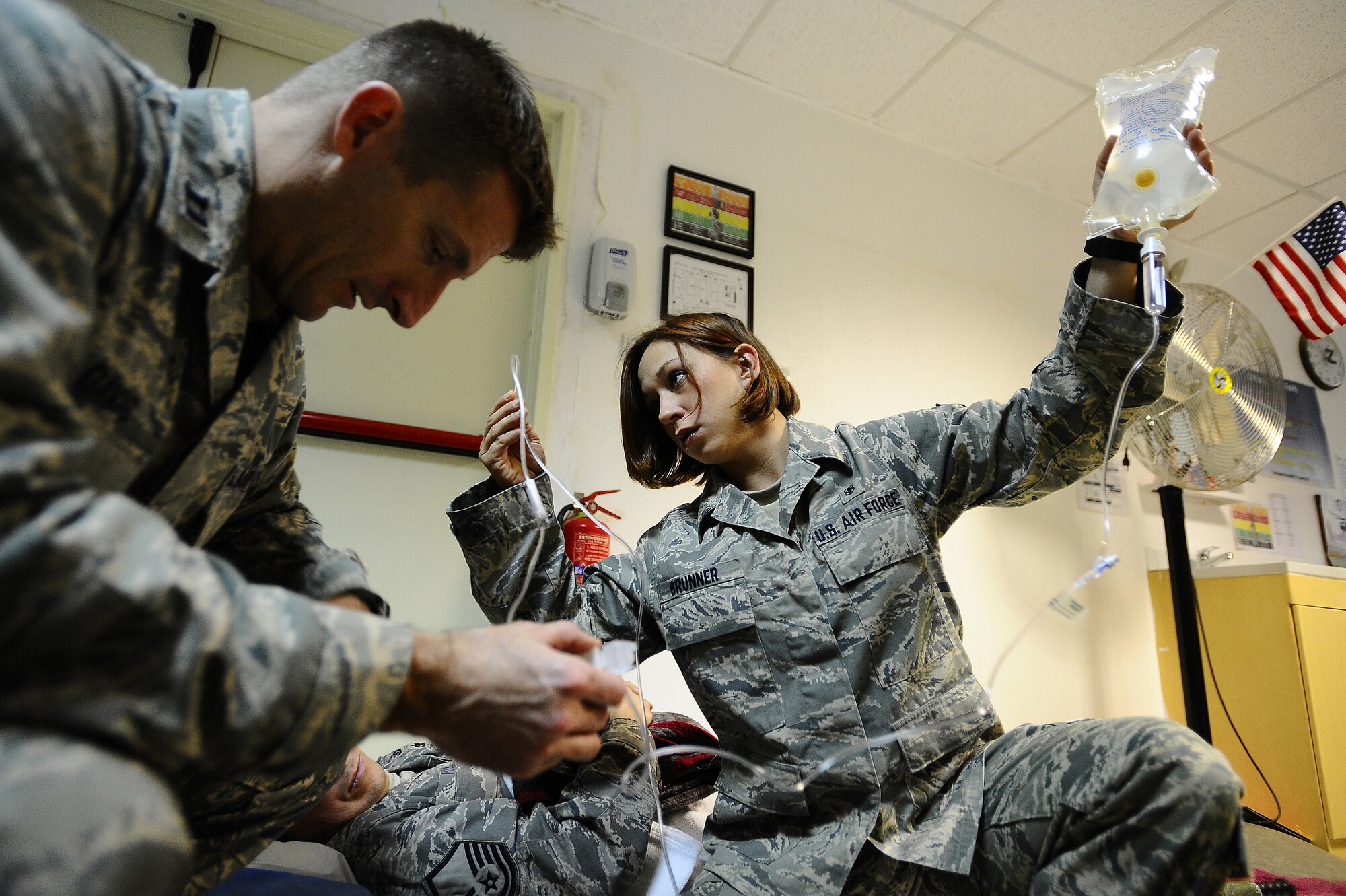 Capt. John Davis troubleshoots an intravenous pump as Senior Airman Samantha Brunner inspects the IV pump's port for any kind of blockage at the Contingency Aeromedical Staging Facility on Joint Base Balad, Iraq, Nov. 27, 2008. Both Airmen are preparing patients for an aeromedical evacuation flight. Airman Brunner, an aerospace medical service journeyman with the 332nd Expeditionary Aerospace Medical Squadron, is a reservist deployed from the 911th Airlift Wing at Pittsburgh International Airport Air Reserve Station, Pa. Captain Davis, a clinical nurse with the 332nd Expeditionary Aerospace Medical Squadron, is deployed from Patrick Air Force Base, Fla. (U.S. Air Force photo/Airman 1st Class Jason Epley)