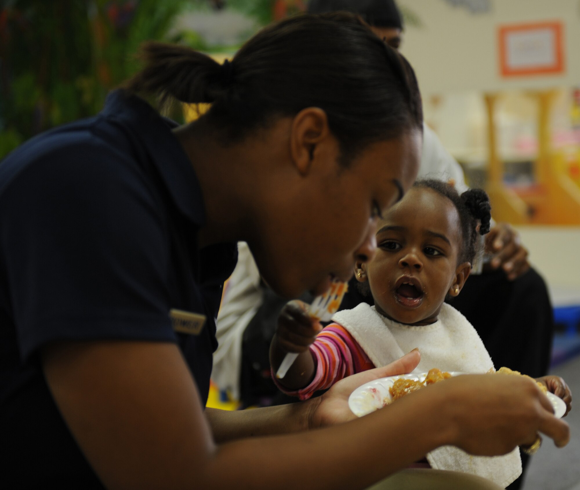 Senior Airman Natasha Thrower, 49th Force Support Squadron, attends the annual Family Feast with her daughter, Daeja, at a Child Develpoment Center at Holloman Air Force Base, N.M., Nov. 24. Parents were invited to come have lunch with their children at the CDC in support of Military family Appreciation Month. (U.S. Air Force photo/Airman 1st Class Michael Means)