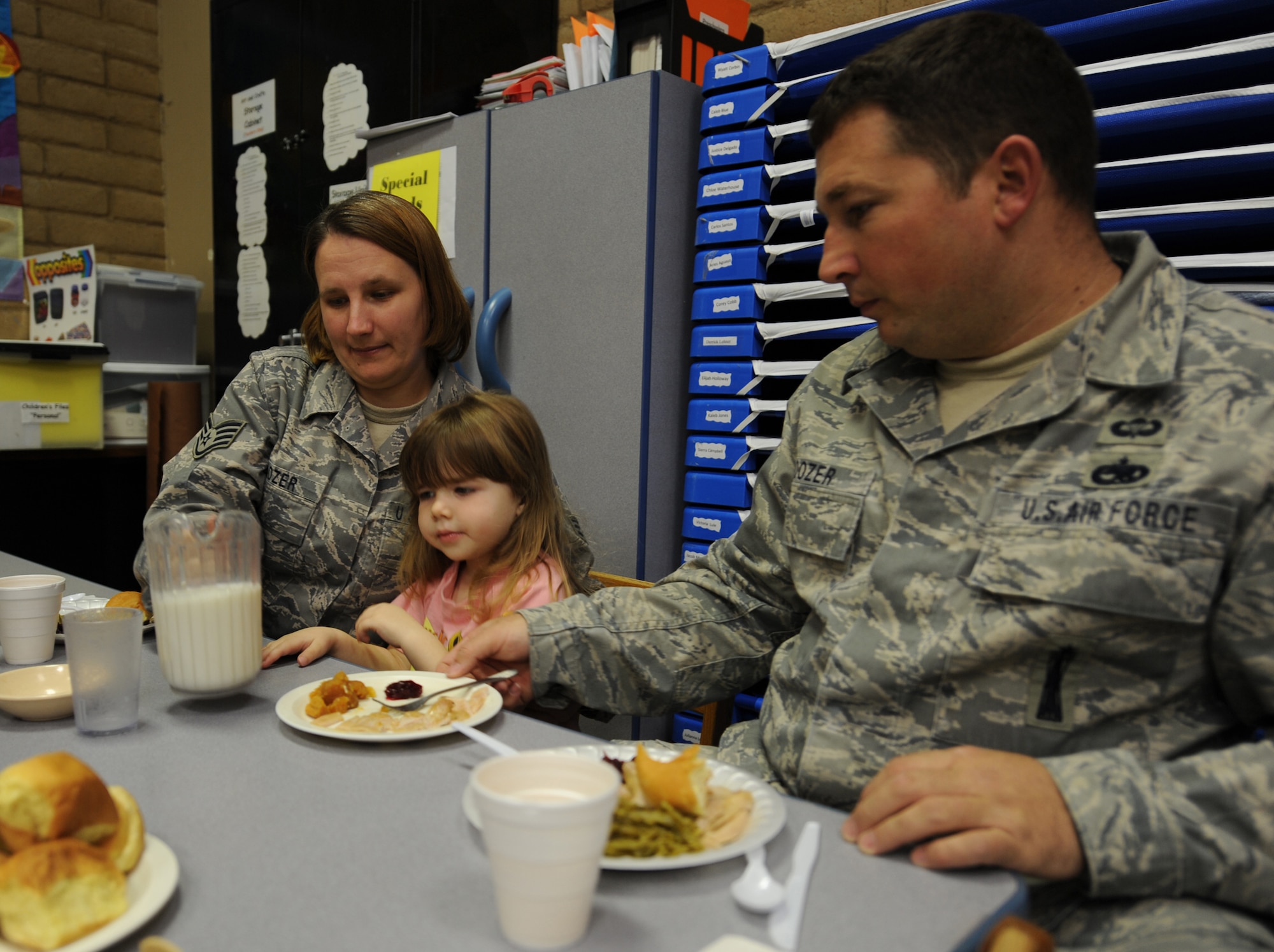 Tech. Sgt. Eric and Staff Sgt. Tara Boozer, 49th Maintenance Operations Squadron, attend the annual Family Feast with their daughter, Zoe, at a Child Develpoment Center at Holloman Air Force Base, N.M., Nov. 24. Parents were invited to come have lunch with their children at the CDC in support of Military family Appreciation Month. (U.S. Air Force photo/Airman 1st Class Michael Means)