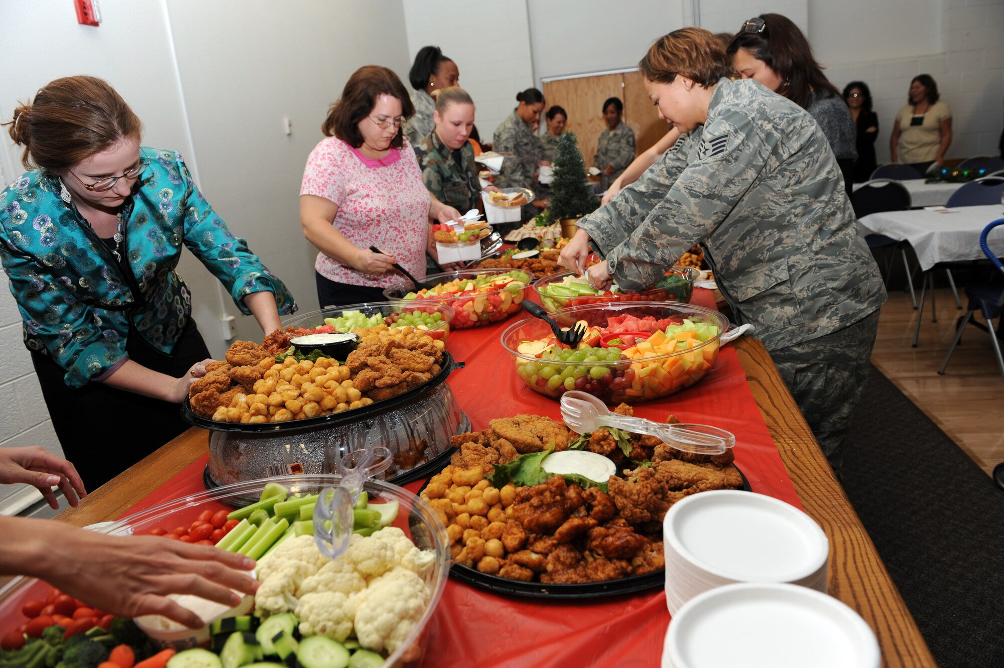 Women who attended the first-ever Women?s Luncheon choose from a variety of food at the Community Center at Holloman Air Force Base, N.M., Dec. 2. The luncheon brought more than 120 women together for spiritual encouragement during the stressful holiday season. (U.S. Air Force photo/Airman Sondra M. Escutia)