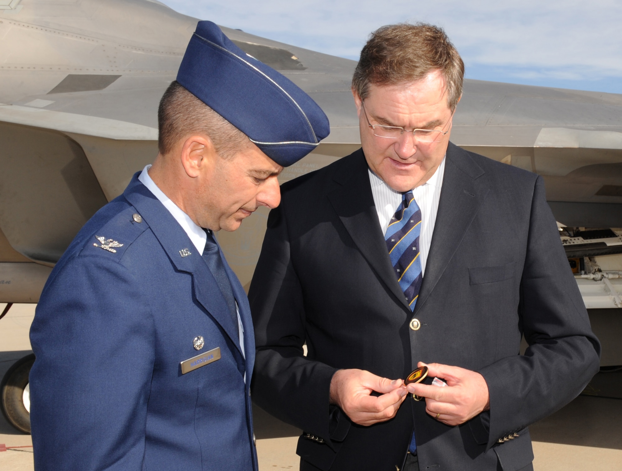 Minister Franz Josef Jung, German Minister of Defense, presents Col. Jeff Harrigian, 49th Fighter Wing commander,  a coin at Holloman Air Force Base, N.M., Nov. 24. Minister Jung came to visit Holloman to see the German Air Force Flying Training Center. The German air force has been training its aircrews throughout the United States since 1958 before it was moved to Holloman in 1992. (U.S. Air Force photo/Airman 1st Class Michael Means)