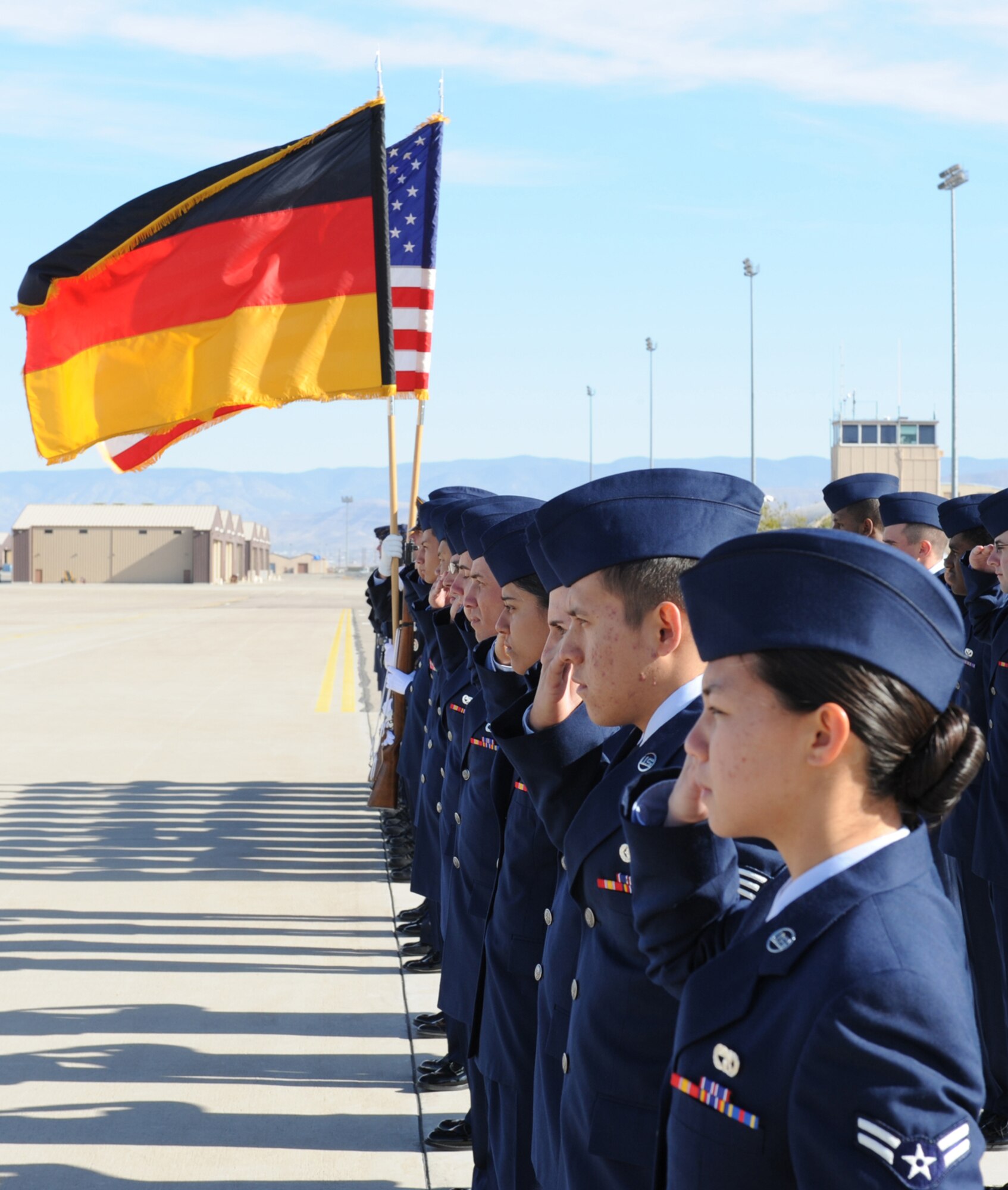 Airmen from the 49th Fighter Wing and the German Air Force Flying Training Center, salute during the arrival of Minister Franz Josef Jung, German Minister of Defense, at Holloman Air Force Base, N.M., Nov. 24. Minister Jung came to visit Holloman to see the German Air Force Flying Training Center. The German air force has been training its aircrews throughout the United States since 1958 before it was moved to Holloman in 1992. (U.S. Air Force photo/Airman 1st Class Michael Means)