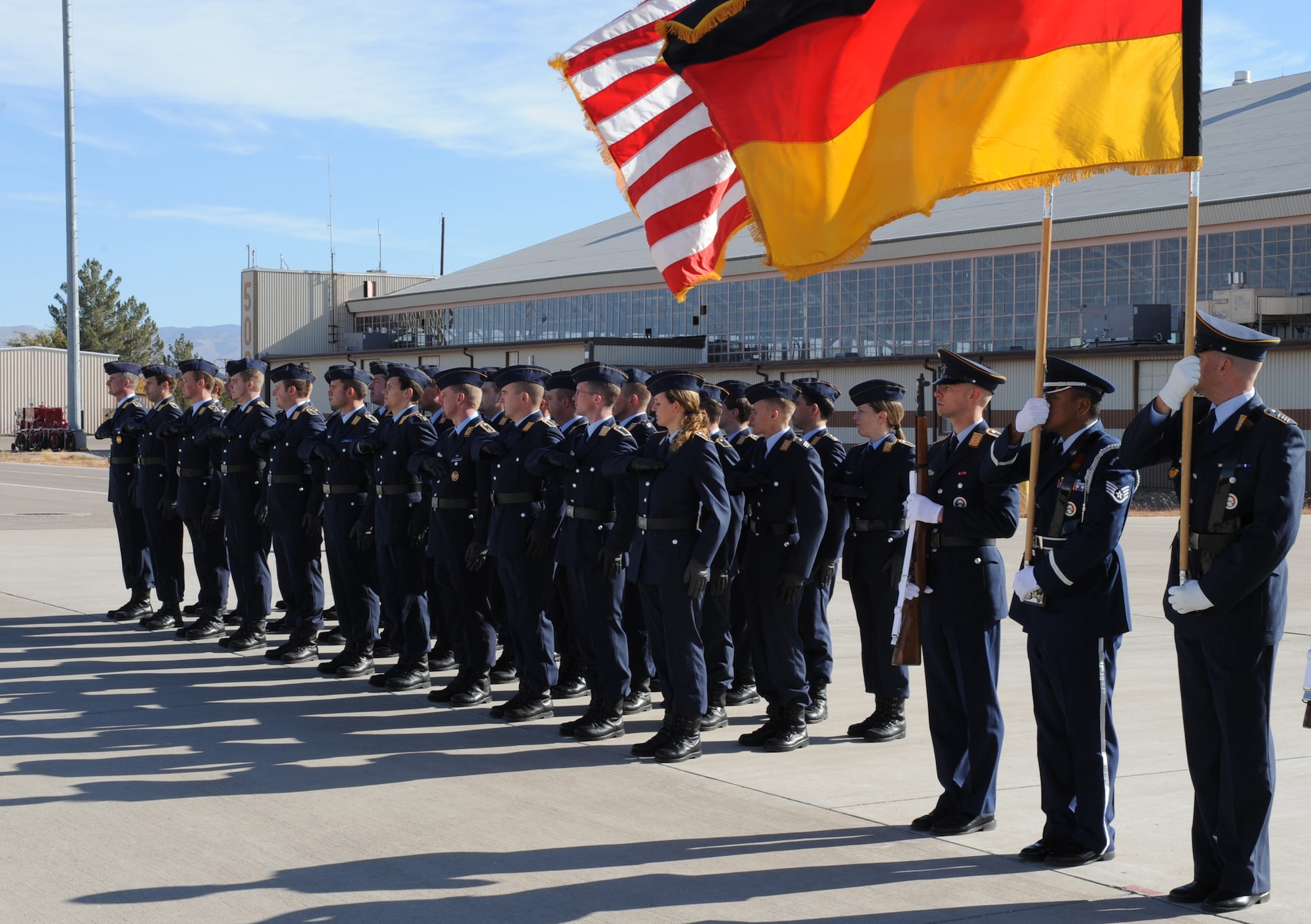 Airmen from the 49th Fighter Wing and the German Air Force Flying Training Center, wait for the arrival of Minister Franz Josef Jung, German Minister of Defense, at Holloman Air Force Base, N.M., Nov. 24. Minister Jung came to visit Holloman to see the German Air Force Flying Training Center. The German air force has been training its aircrews throughout the United States since 1958 before it was moved to Holloman in 1992. (U.S. Air Force photo/Airman 1st Class Michael Means)