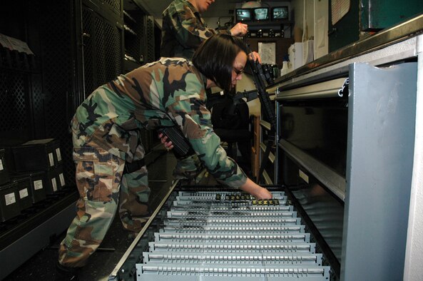 Airman 1st Class Vanessa Arnold, 341st Security Support Squadron armorer, places 5.56mm rifle ammunition in a drawer in the 341st SSPTS armory Nov. 25. (U.S. Air Force photo/Senior Airman Dillon White)