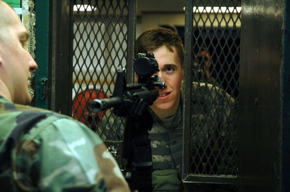 A security forces Airman watches as Senior Airman Ryan Morse, 341st Security Support Squadron armorer, inspects the returned weapon for cleanliness Nov 25. (U.S. Air Force photo/Senior Airman Dillon White)