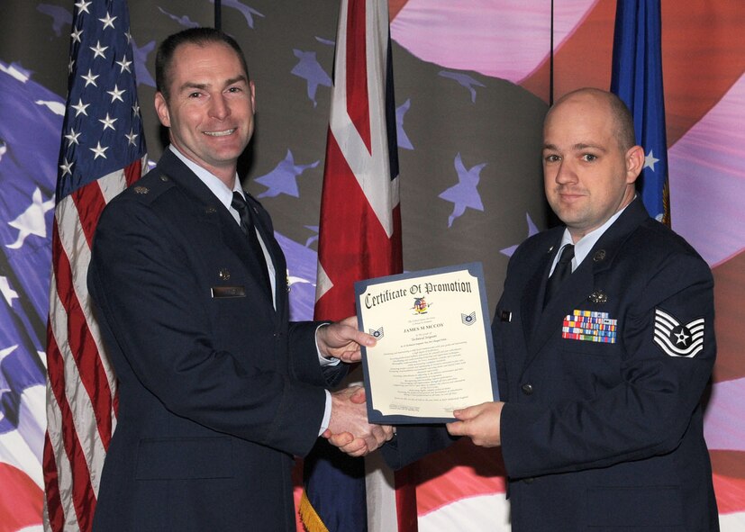 Staff Sgt. James McCoy is promoted to the rank of technical sergeant by Lt. Col. Richard L. Smith, the 100th Logistics Readiness Squadron commander, during the promotion ceremony held at the Galaxy Club Nov. 26, 2008, in RAF Mildenhall, England. (U.S. Air Force photo by Staff Sgt. Jerry Fleshman)