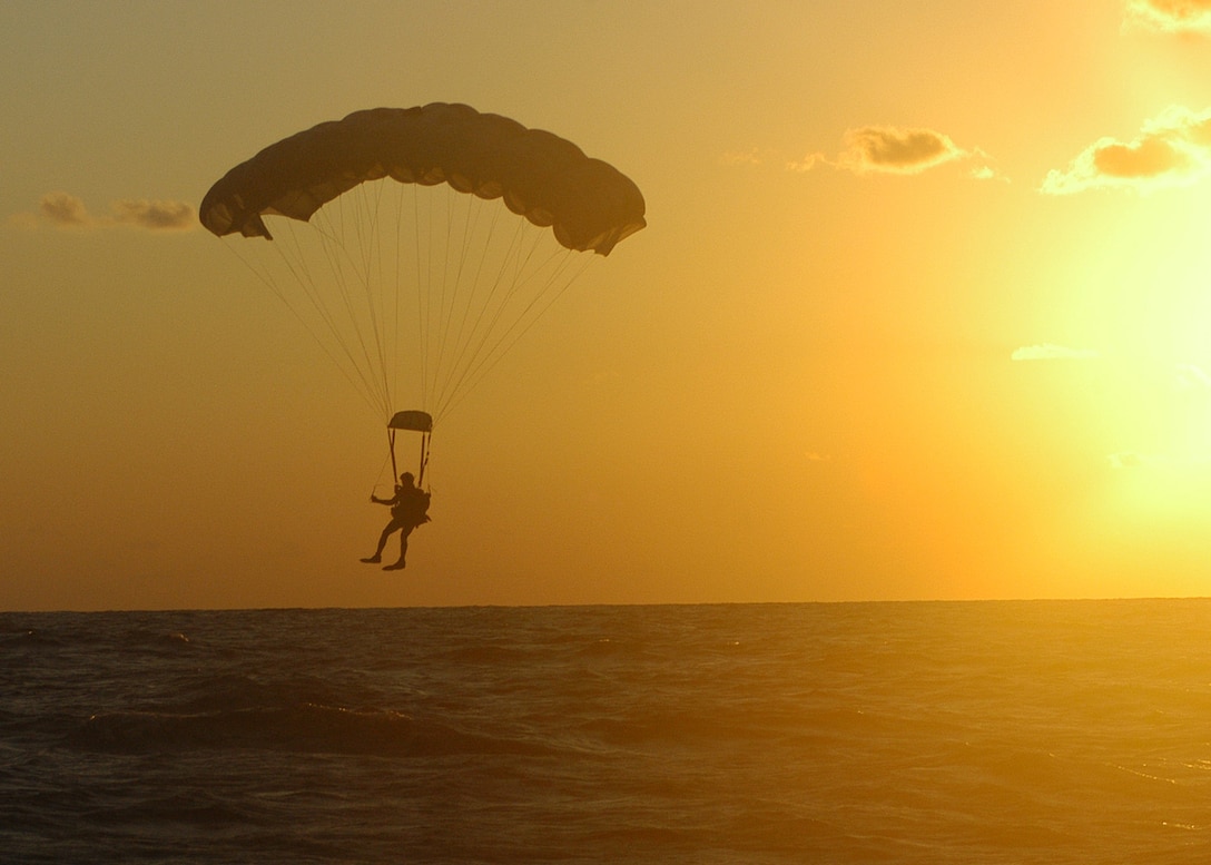 KADENA AIR BASE, Japan -- A pararescueman from the 320th Special Tactics Squadron prepares to land in the ocean  after jumping from a 1st Special Operations Squadron MC-130H Combat Talon II here Dec. 2.  The pararescueman was one of seven 320th STS members that parachuted into the water to search for survivors of a simulated aircraft accident. The event was part of a 353rd Special Operations Group training exercise testing the group?s ability to conduct search and rescue operations from start to finish. (U.S. Air Force photo by Tech. Sgt. Aaron Cram)                                 