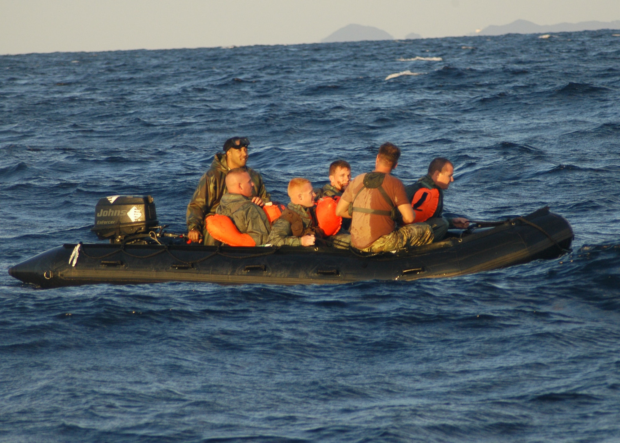 KADENA AIR BASE, Japan -- A Survival, Evasion, Resistance and Escape, or SERE, specialist assigned to the 353rd Operations Support Squadron and a member of the 320th Special Tactics Squadron prepare to drop four airmen playing survivors of a simulated aircraft accident into the water during a training exercise here Dec. 2. Pararescuemen and combat controllers from the 320th STS jumped from a MC-130H Combat Talon II to search for, and recover, the survivors. The event was part of a 353rd Special Operations Group training exercise testing the group?s ability to conduct search and rescue operations from start to finish. (U.S. Air Force photo by Tech. Sgt. Aaron Cram)                                  
