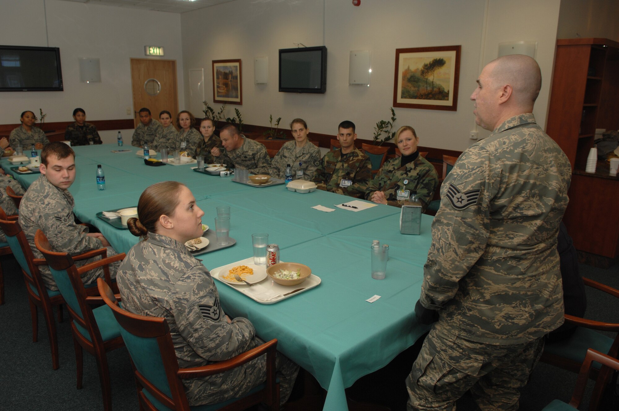 Staff Sgt. Matthew Slaydon talks to a group of Air Force service members working at Landstuhl Regional Medical Center over lunch at the LRMC Dining Facility, Landstuhl Regional Medical Center, Germany, Nov. 21, 2008. Sgt. Slaydon was severely injured in Iraq 13 months ago during a deployment there as an explosive ordinance disposal technician and is visiting LRMC as part of a morale tour, following his recovery. (U.S. Air Force photo by Airman 1st Class Tony R. Ritter)