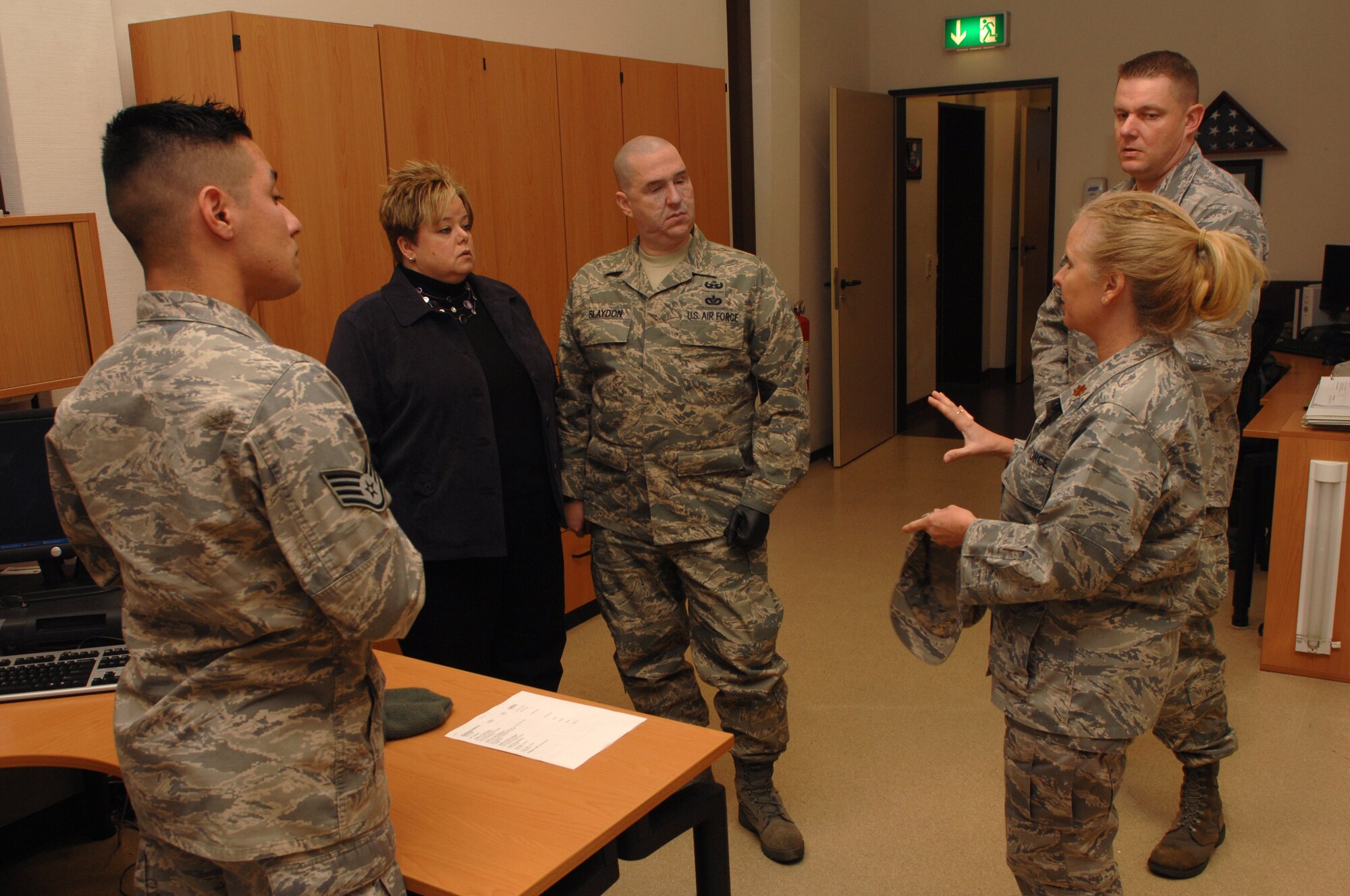 Maj. Laurie Turner (right), 435th Contingency Aeromedical Staging Facility medical service corps officer, and CASF team members, explain the daily operations of the CASF to Staff Sgt. Matthew Slaydon (center) and his wife, Annette, Ramstein Air Base, Germany, Nov. 21, 2008. Sgt. Slaydon was severely injured in Iraq 13 months ago during a deployment there as an explosive ordinance disposal technician and is visiting Ramstein as part of a morale tour, following his recovery. (U.S. Air Force photo by Airman 1st Class Tony R. Ritter)
