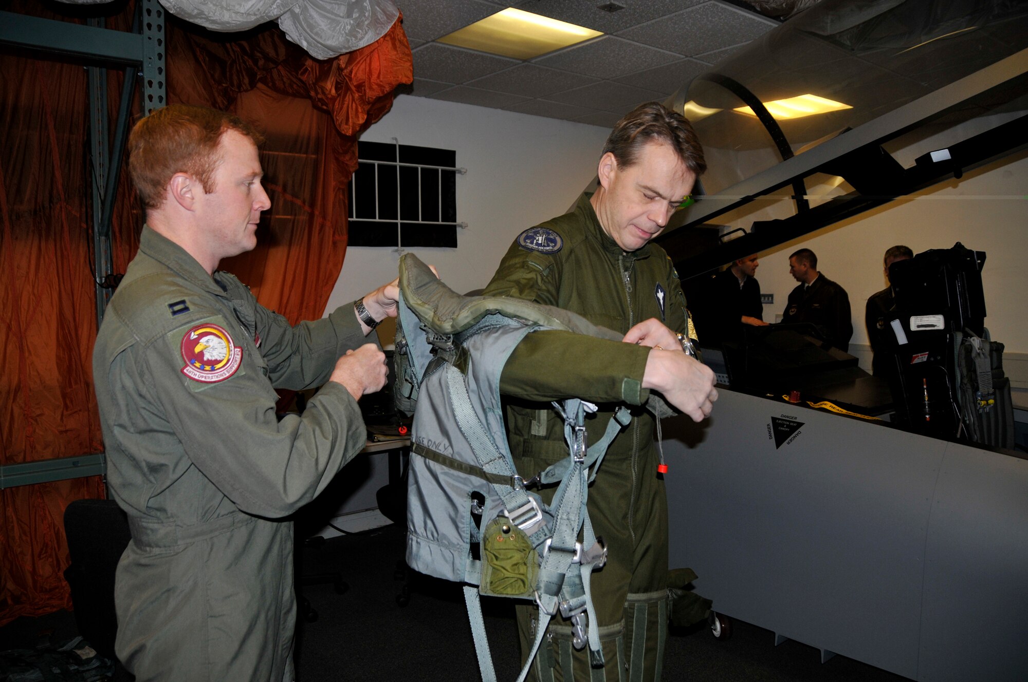 Capt. Timothy Tendall, 492nd Fighter Squadron assists Maj. Gen. Anders Silwer, Swedish Air Force Chief of Staff with putting on the G-suit Dec. 1 at RAF Lakenheath, England. Members of the Swedish Air Force were invited to Lakenheath to build professional and personal relationships with Swedish Air Force Senior Leaders. (U.S. Air Force photo by Airman 1st Class Perry Aston) 
