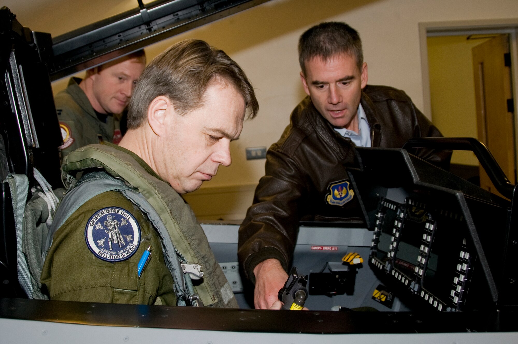 Col. Jay Silveria, 48th Fighter Wing Commander , shows Maj. Gen. Anders Silwer, Swedish Air Force Chief of Staff  where he will connect his g-suit hose Dec. 1 at RAF Lakenheath, England. Members of the Swedish Air Force were invited to Lakenheath to build professional and personal relationships with Swedish Air Force Senior Leaders. (U.S. Air Force photo by Airman 1st Class Perry Aston) 