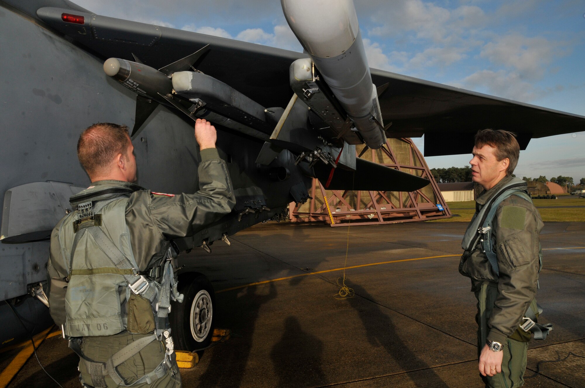 Capt. William Wooten, 494th Fighter Squadron, and Maj. Gen. Anders Silwer, Swedish Air Force Chief of Staff discusss the different types of weapons the F-15 Strike Eagle is capable of delivering Dec. 1 at RAF Lakenheath, England. Members of the Swedish Air Force were invited to Lakenheath to build professional and personal relationships with Swedish Air Force Senior Leaders. (U.S. Air Force photo by Airman 1st Class Perry Aston)