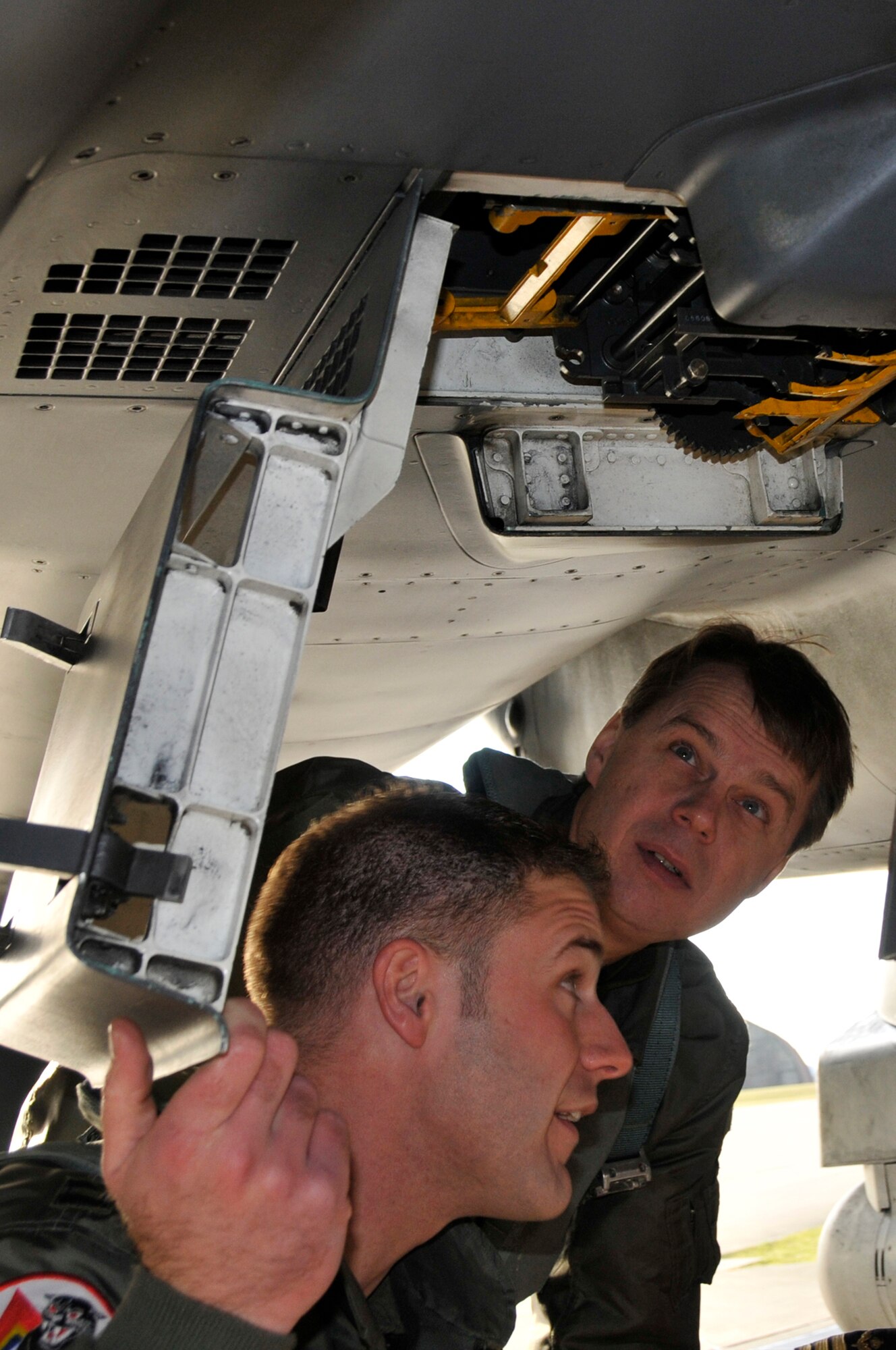 Capt. William Wooten, 494th Fighter Squadron, shows Maj. Gen. Anders Silwer, Swedish Air Force Chief of Staff the location of the F-15 Strike Eagle's magazine for the 20mm gun Dec. 1 at RAF Lakenheath, England. Members of the Swedish Air Force were invited to Lakenheath to build professional and personal relationships with Swedish Air Force Senior Leaders. (U.S. Air Force photo by Airman 1st Class Perry Aston)  