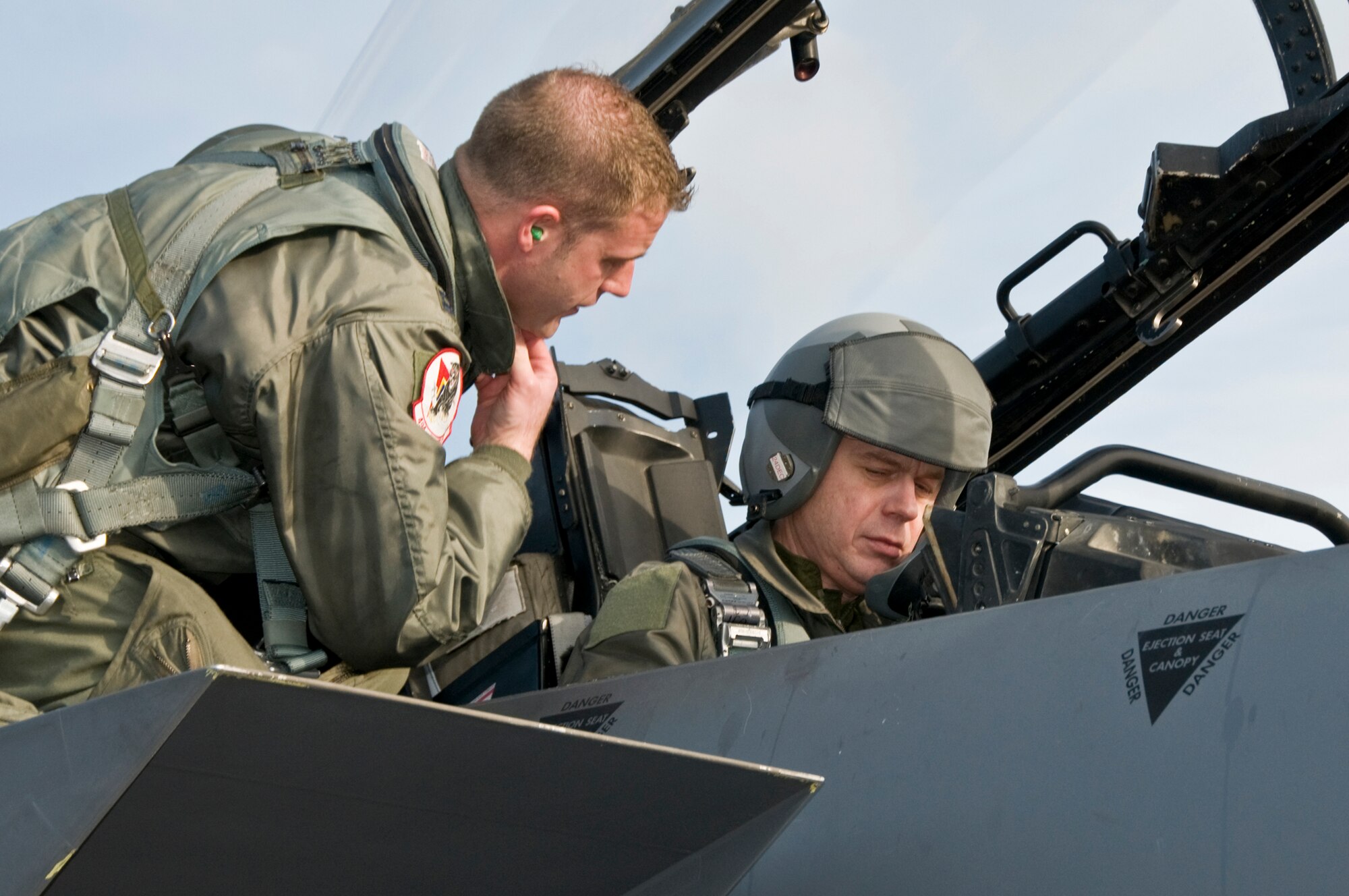 Capt. William Wooten, 494th Fighter Squadron, helps Maj. Gen. Anders Silwer, Swedish Air Force Chief of Staff, get familiar with the controls of the F-15 Strike Eagle Dec. 1 at RAF Lakenheath, England. Members of the Swedish Air Force were invited to Lakenheath to build professional and personal relationships with Swedish Air Force Senior Leaders. (U.S. Air Force photo by Airman 1st Class Perry Aston)