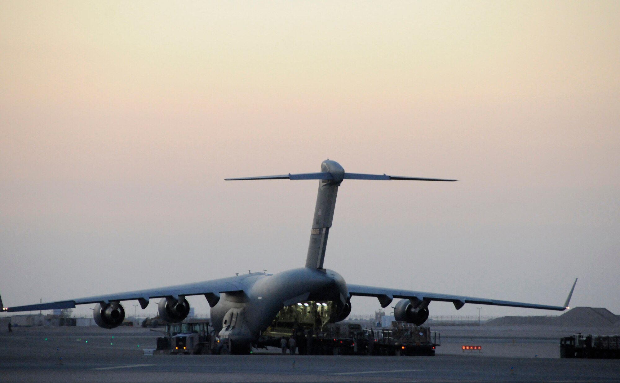 Air transportation technicians assigned to the 8th Expeditionary Air Mobility Squadron, with an assist from crew chiefs from the 816th Expeditionary Airlift Squadron, prepare a load of munitions for transport on a C-17 Globemaster III, Dec. 3, at an undisclosed air base in Southwest Asia.  The C-17 is capable of rapid strategic delivery of troops and all types of cargo to main operating bases or directly to forward bases in the deployment area.  The cargo is being transported further into the Central Command area of responsibility in support of Operations Iraqi and Enduring Freedom.  (U.S. Air Force photo by Tech. Sgt. Michael Boquette/Released)