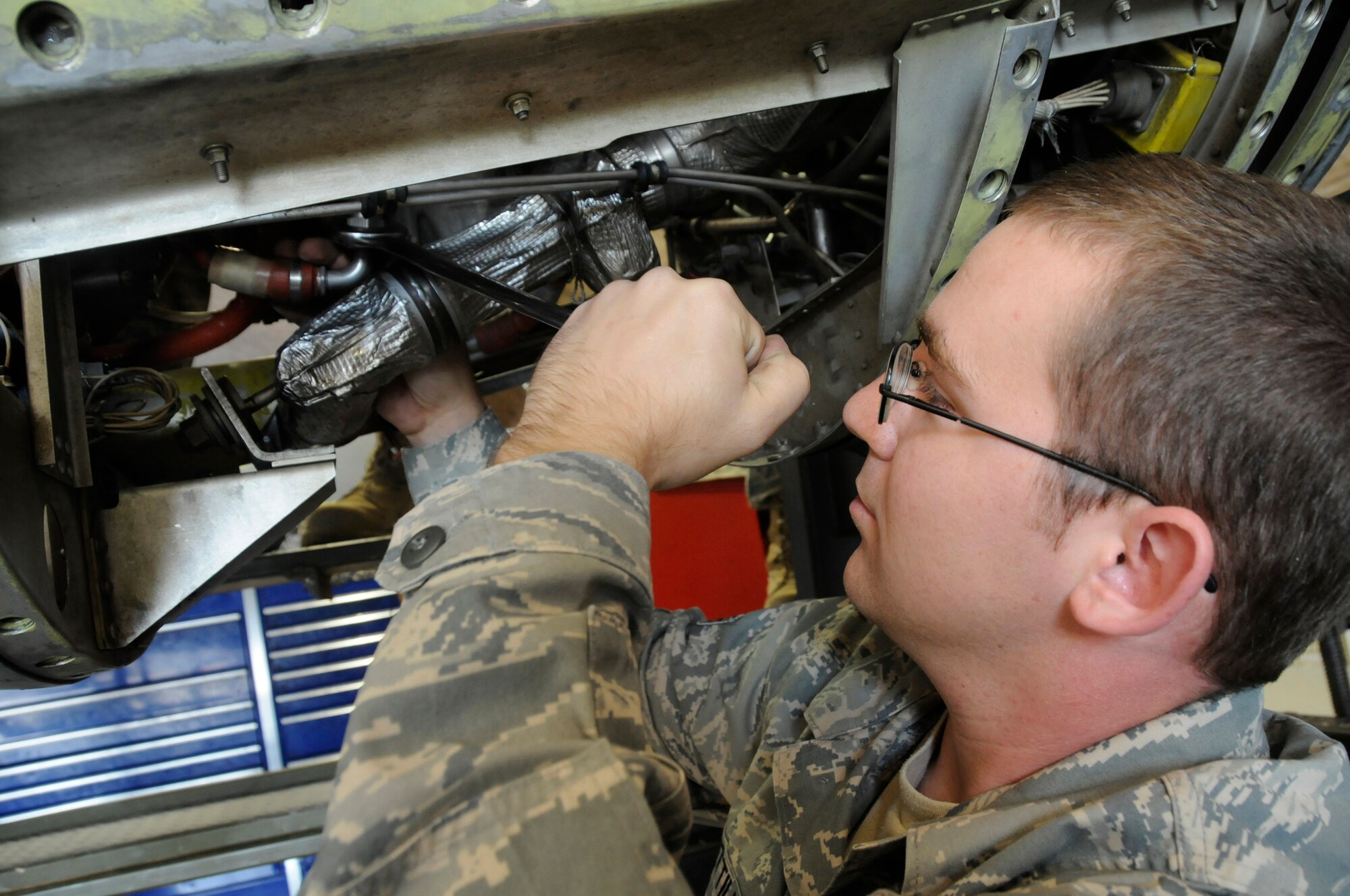 Senior Airman Lonnie Cuttill, aerospace turbo propulsion journeyman assigned to the 379th Expeditionary Maintenance Squadron, tightens a fuel line on a C-130 T56-15 turbo propeller Dec. 3, at an undisclosed air base in Southwest Asia. EMXS maintainers are responsible for ensuring all aircraft stay mission capable to support the Global War on Terror.  Airman Cuttill, a native of Decatur, Ill., is deployed from Little Rock Air Force Base, Ark., in support of Operations Iraqi and Enduring Freedom and Joint Task Force-Horn of Africa. (U.S. Air Force photo by Staff Sgt. Darnell T. Cannady/Released)