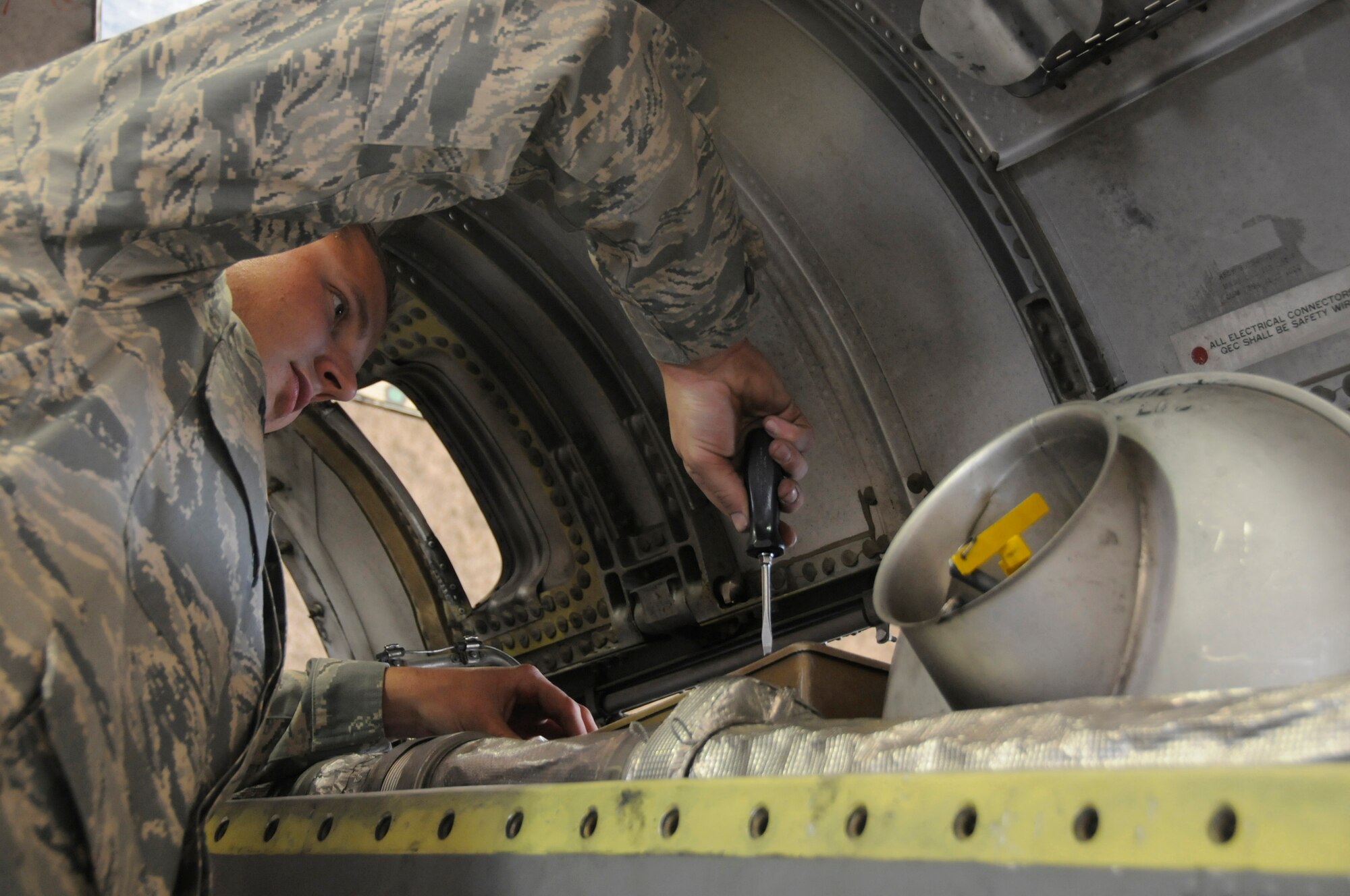 Senior Airman Joshua Ray, aerospace turbo propulsion journeyman assigned to the 379th Expeditionary Maintenance Squadron, removes a cover from an engine junction box of a C-130 T56-15 turbo propeller Dec. 3, at an undisclosed air base in Southwest Asia.  EMXS maintainers are responsible for ensuring all aircraft stay mission capable to support the Global War on Terror.  Airman Ray, a native of Miami, Fla., is deployed from Yokota Air Base, Japan, in support of Operations Iraqi and Enduring Freedom and Joint Task Force-Horn of Africa. (U.S. Air Force photo by Staff Sgt. Darnell T. Cannady/Released)