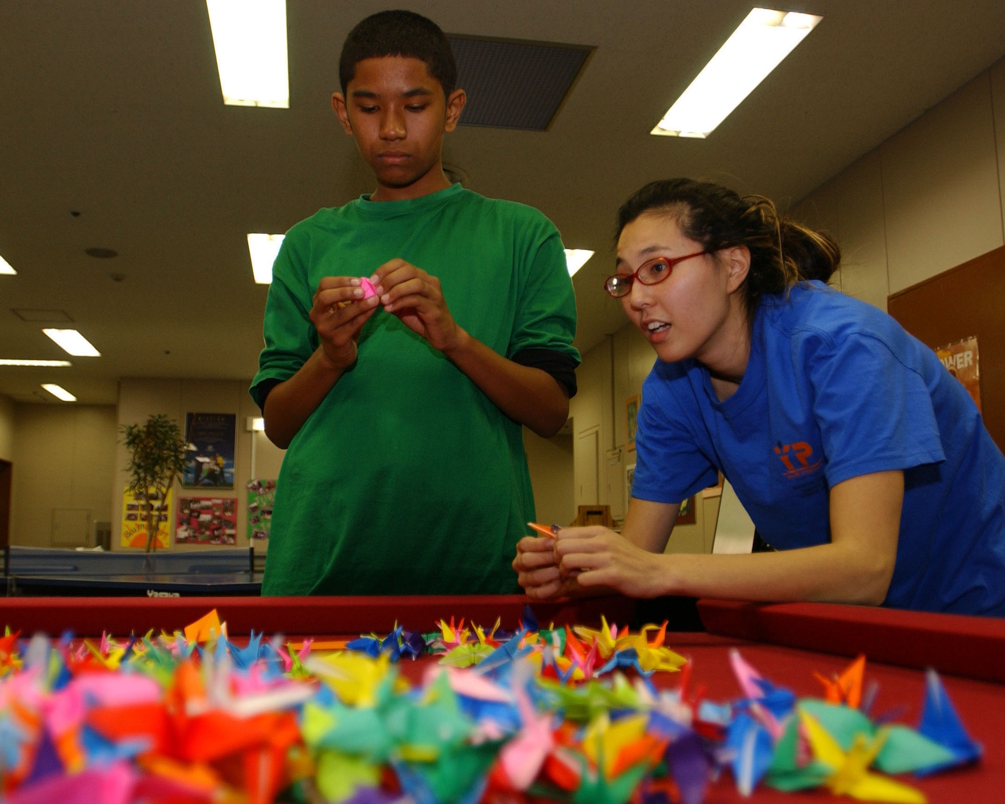 Yokota Air Base, - Michael Henagan and Shawna  Vitarbo, participate in the 1,000 paper cranes project at the Yokota Teen Center Japan Dec. 1. The 1,000 paper Cranes project is a tribute to a young Japanese girl named Sadako Sasaki. Old Japanese legend states that if one person can fold 1,000 cranes that, that person will be granted one wish, such as long life or have an illness cured.(U.S. Air Force photo by Airman 1st Class Michael Dillon)                              