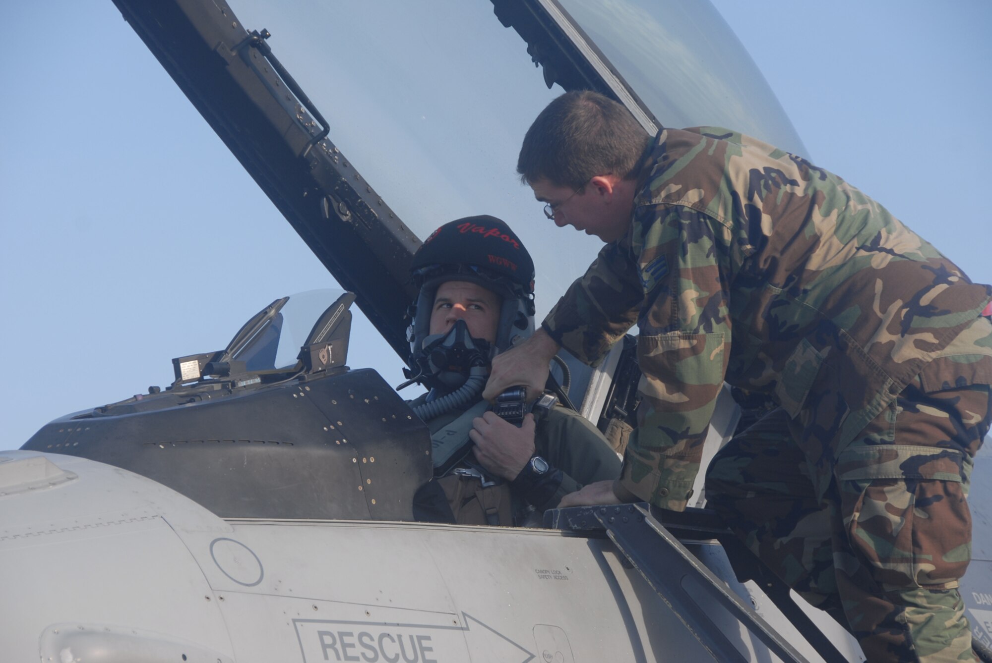 Komatsu Air Base, Japan -- Senior Airman Matthew Horn, 35th Aircraft Maintenance Squadron crew chief, assists Capt. Brian Sullivan, 13th Fighter Squadron pilot, before launching their F-16 to fly an air-to-air combat sortie with Japan Air Self-Defense Force 6th Air Wing pilots Dec. 3, 2008 in the skies over Komatsu Air Base, Japan. (U.S. Air Force photo by Staff Sgt. Kelly White)
