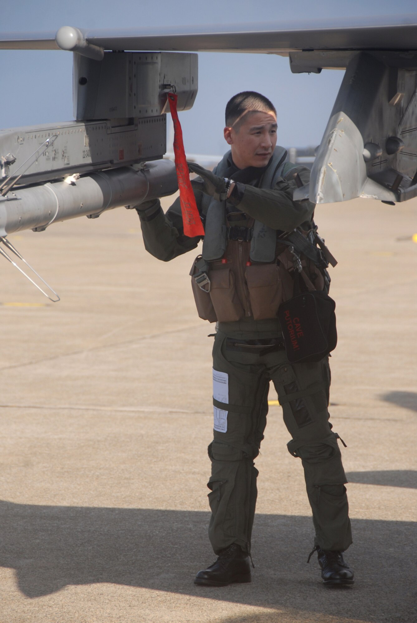 Komatsu Air Base, Japan -- Capt. Brian Suh, 13th Fighter Squadron pilot, performs a "walkaround" inspection prior to an Aircraft Training Relocation event sortie Dec. 2, 2008. Captain Suh is one of more than 80 Misawa members deployed to Japan Air Self-Defense Force 6th Air Wing in Komatsu, Japan, in support of the week-long air-to-air combat training event where 13th FS F-16 pilots flew sorties with 6th AW F-15 pilots. (U.S. Air Force photo by Staff Sgt. Kelly White)
