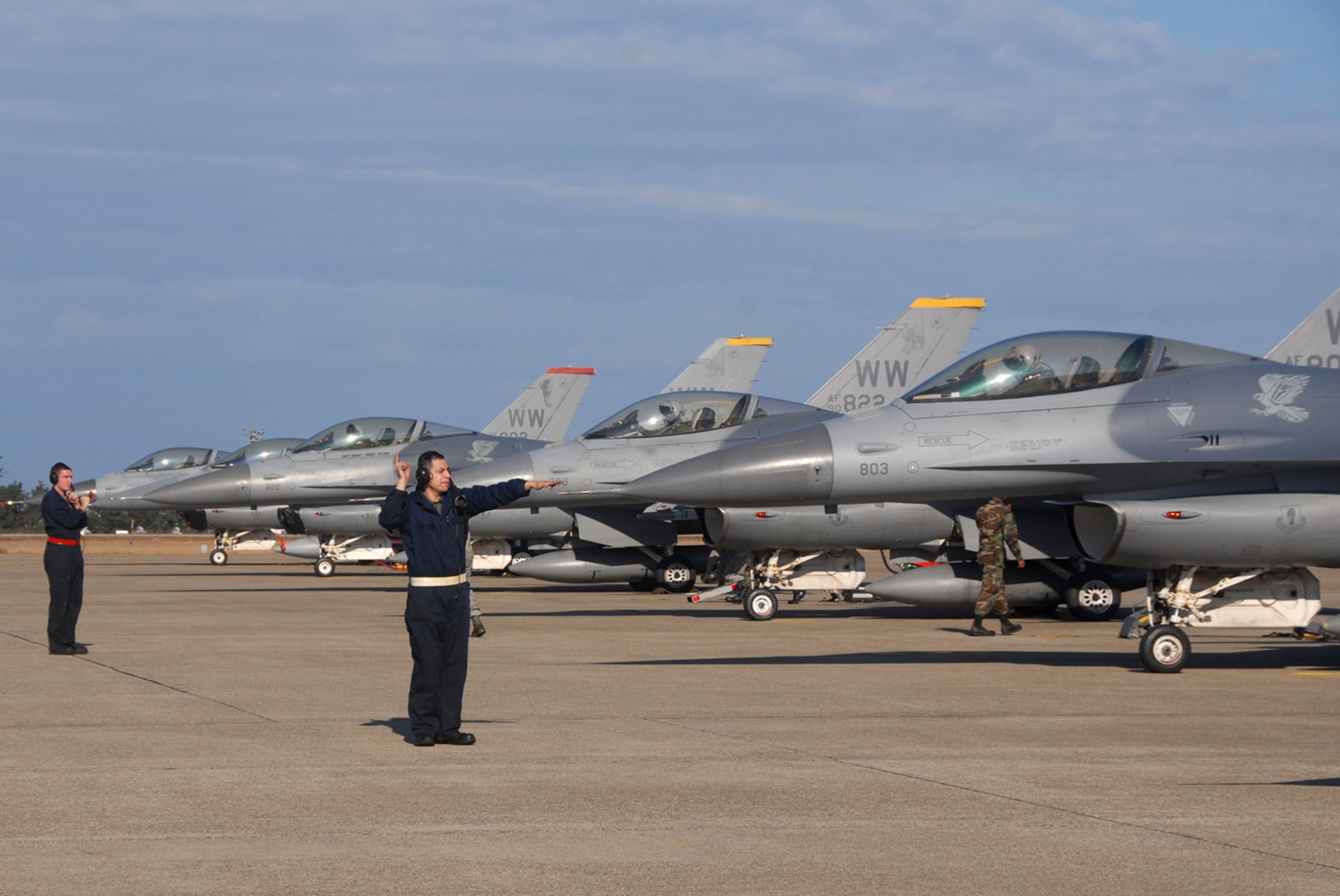 Komatsu Air Base, Japan -- Airman 1st Class Jessie Arenal (front) and Senior Airman Matthew Horn, 35th Aircraft Maintenance Squadron crew chiefs, launch F-16 aircraft on the Japan Air Self-Defense Force 6th Air Wing flightline Dec. 2, 2008 during an Aircraft Training Relocation event. During the week-long event, 13th Fighter Squadron and 6th AW pilots honed their air-to-air combat skills. This ATR afforded 13th FS pilots an opportunity to train against JASDF F-15s. (U.S. Air Force photo by Staff Sgt. Kelly White)