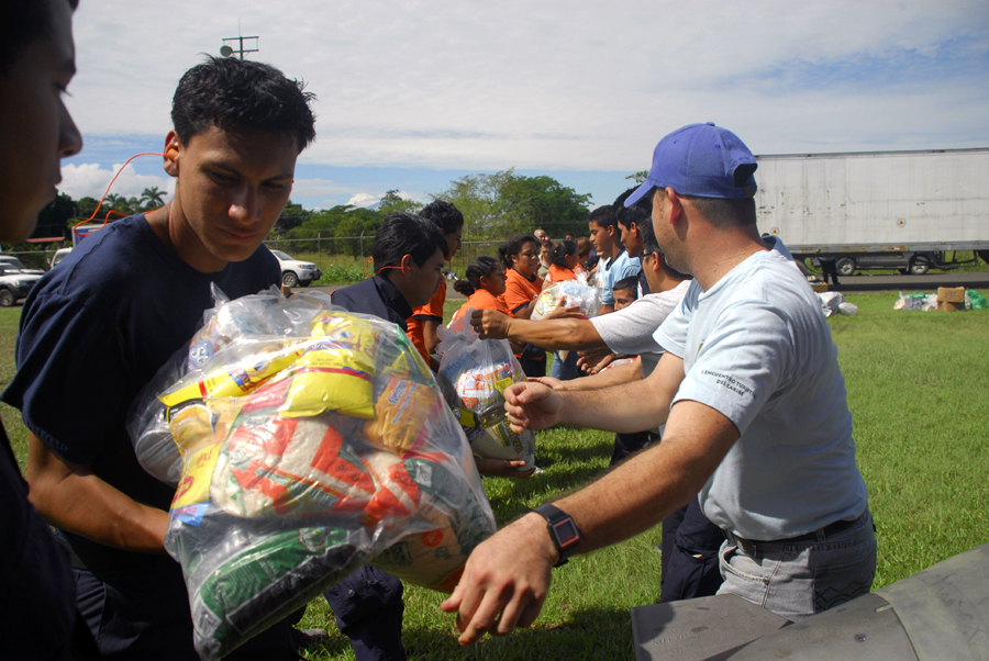 Costa Rican National Emergency Commision and Red Cross workers form a