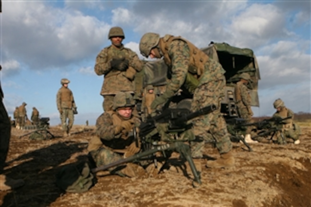 U.S. Marine Corps Warrant Officer Matthew E. Robinson and Lance Cpl. Steven J. Baumker with 3rd Battalion, 12th Marine Regiment perform final inspections on an M-294 squad automatic weapon in Hokkaido, Japan, on Nov. 20, 2008.  