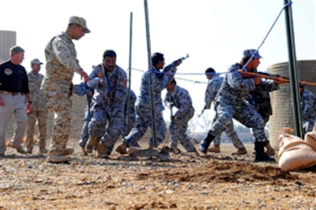 A Delta Sustainment Training & Refresher Course instructor runs Iraqi policemen through room clearing procedures at the Iraqi Police Academy on Forward Operating Base Delta, in Al Kut, Iraq, Dec. 3, 2008. The Iraqi policemen attend a two-week training refresher
course to help maintain the security of their city of Al Kut, Iraq.