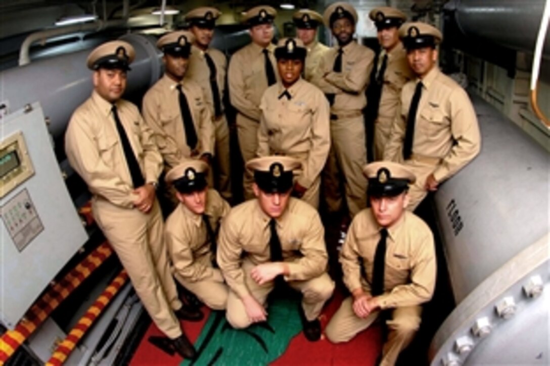 Chief petty officers pose for an "old-school" style photo in arresting gear engine room three aboard the aircraft carrier USS Theodore Roosevelt, in the Gulf of Oman, Dec. 2, 2008. 