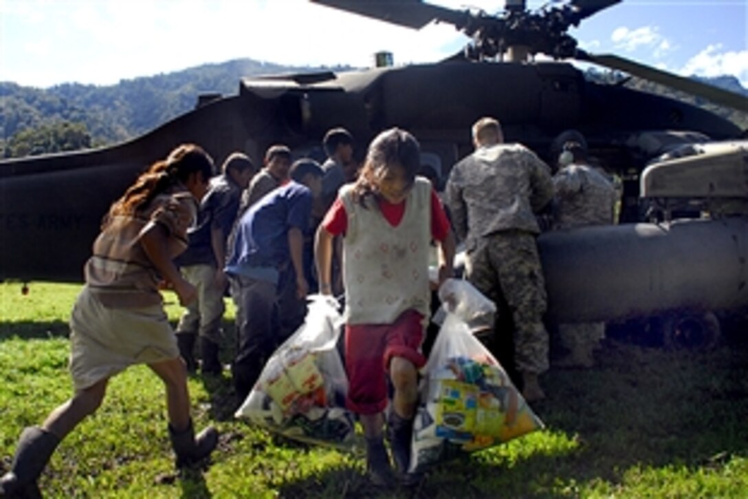 A child from a remote village in Costa Rica carries back food and supplies that were delivered by members of Joint Task Force-Bravo, Dec. 1, 2008. The remote villages are inaccessable by vehicle; the journey there can take up to three days on foot.