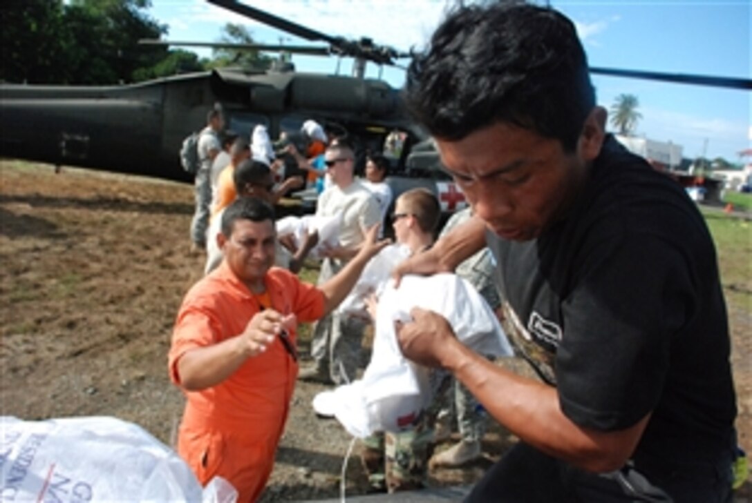Volunteers from the Panamanian civil protection organization load flood relief supplies onto a Joint Task Force-Bravo UH-60 Black Hawk helicopter here Dec. 1, 2008. Since Nov. 26, eight JTF-Bravo helicopters have moved more than 235,000 pounds of relief supplies and evacuated 17 people in need of medical attention in flood-affected areas of Costa Rica and Panama. 