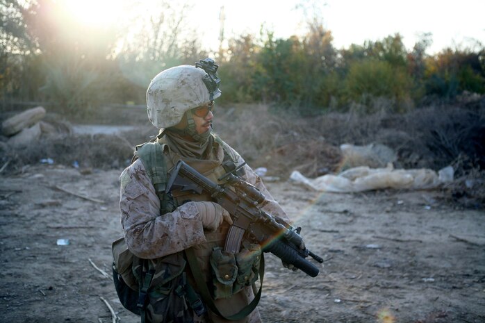 Cpl. Jordan Carranza, a fire team leader with Provisional Rifle Platoon 3, Regimental Combat Team 5, keeps alert during a pause in a patrol Dec. 4 in Rawah, Iraq. The PRP-3 Marines kept watch over the Rawah Bridge, once used as a thoroughfare for insurgents coming to western al Anbar province, Iraq, and now used for local traffic, contractors, and shepherds.  The platoon recently completed a two-month assignment as security for Traffic Control Points 3 and 4, which are on the Rawah Bridge.