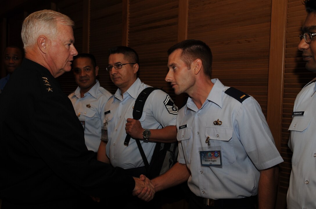 2nd Lt. Kenny Ruggles, 624th Regional Support Group, receives a coin from Navy Admiral Timothy J. Keating, Commander, United States Pacific Command, in recognition of his efforts in planning the 2008 Chiefs of Defense Conference in Bali, Indonesia, November 13, 2008.  Lieutenant Ruggles is a reservist with the 48th Aerial Port Squadron based at Hickam Air Force Base, Hawaii, and served as this year's conference coordinator for the annual event.  Indonesia co-hosted this year's CHOD conference, which is an annual gathering of the Joint Chiefs of Staff equivalents from Asia Pacific nations.  (U.S. Navy photo by MC2 Elisia Gonzales)