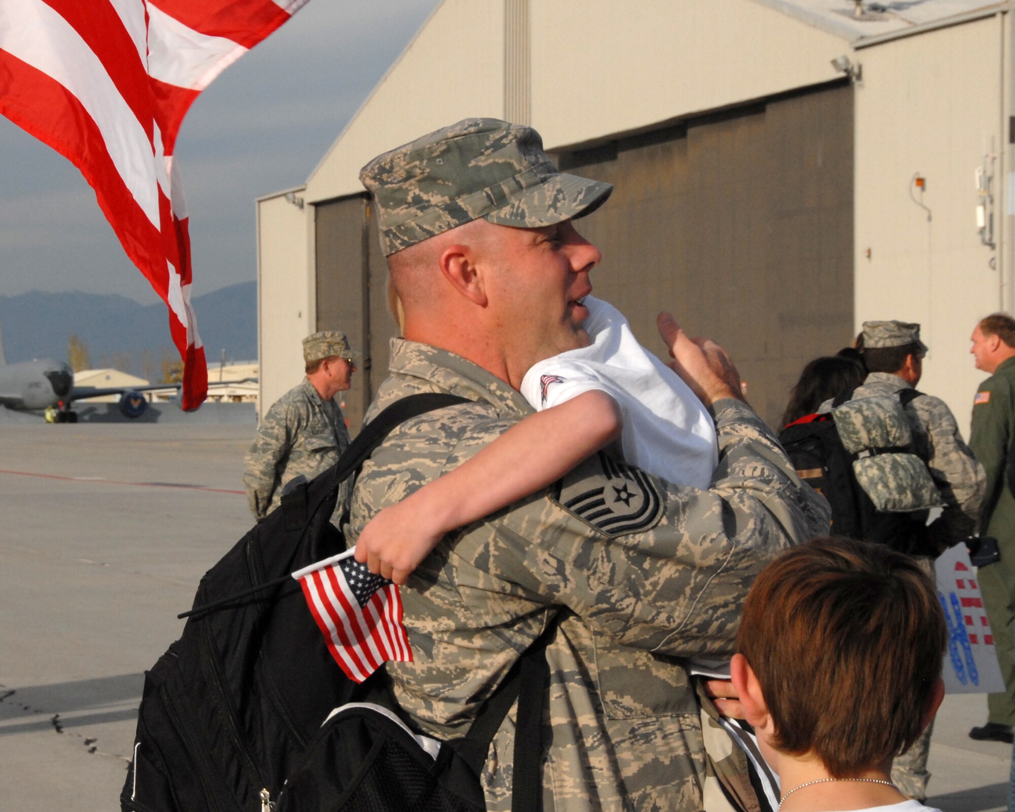 SALT LAKE CITY - Master Sgt. Brent Davis from the 151st Security Forces Squadron, Utah Air National Guard, hugs his children after returning from a six-month deployment to the Kingdom of Saudi Arabia.  Twenty two SFS Airmen arrived back to a crowd of friends and family members on Nov. 22, 2008.  The squadron members were deployed in support of Operation Iraqi Freedom.  U.S. Air Force photo by Staff Sgt. Emily Monson