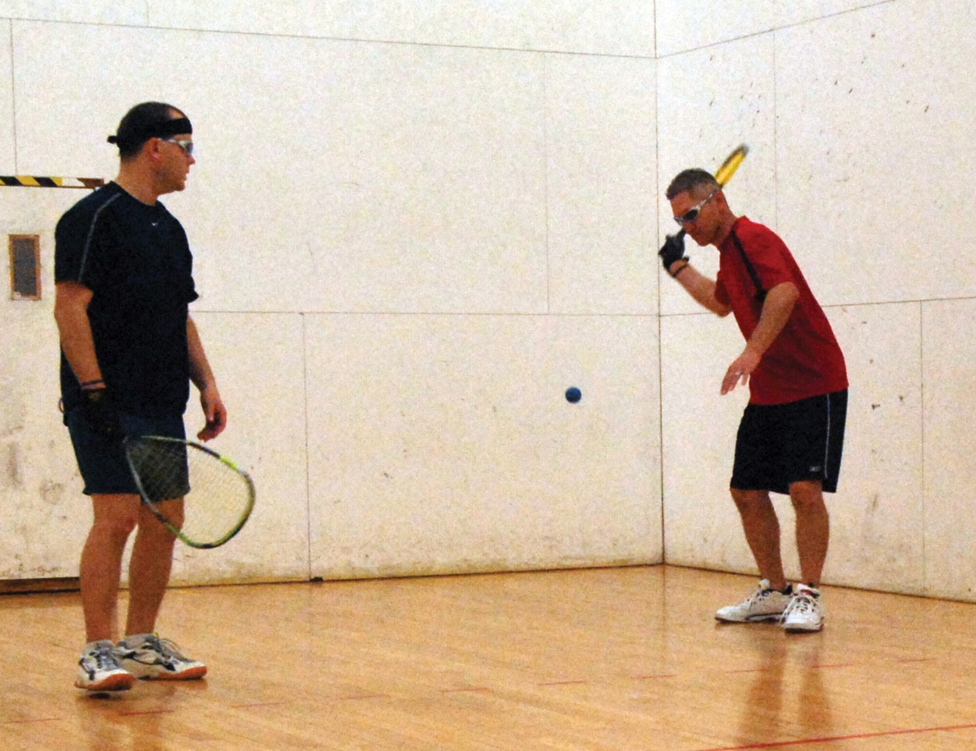 Todd Elias, 56th Equipment Maintenance Squadron, returns the ball during a match against Frederick Nolan. Elias recently won the gold in the All-Military National Racquetball CHampionship held in San Diego. Elias and his partner, Chad Jennings of the 61st Fighter Squadron, also won the silver in the doubles tournament. (Photo by Airman 1st Class C.J. Hatch)