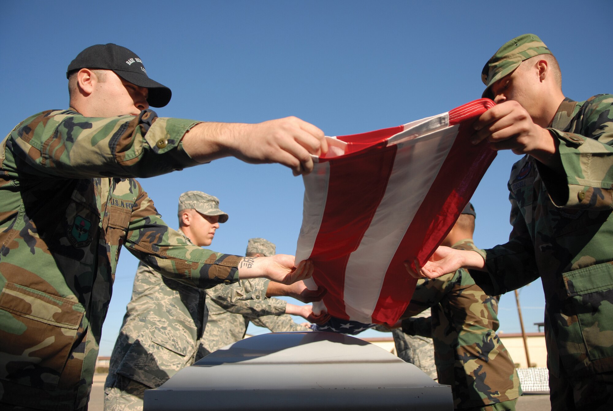 Members of the Luke Honor Guard practice ceremonial procedures int he back parking lot of the Airman Leadership School Dec. 3. (Photo by Airman 1st Class Ronifel Yasay)