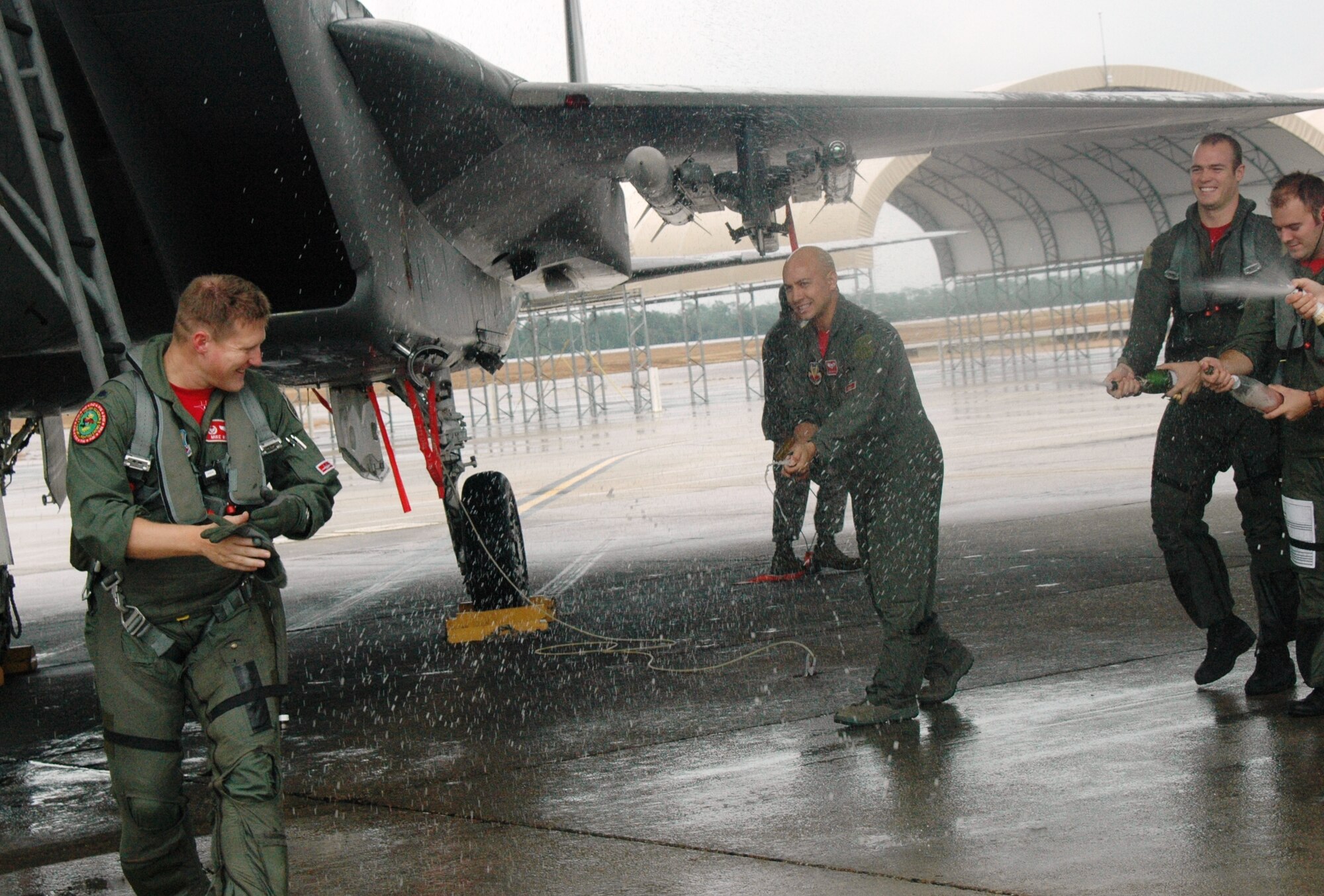 Lt. Col. Mike Winkler, 60th Fighter Squadron commander, recieves the traditional Air Force fini flight wet down by fellow "Fighting Crows."  It wasn't the end of the pilot's career but the final 60th FS sortie for the unit that will realign under the 58th Fighter Squadron in preparation for the 33rd Fighter Wing's drawdown. (U.S. Air Force Photo/Chrissy Cuttita)