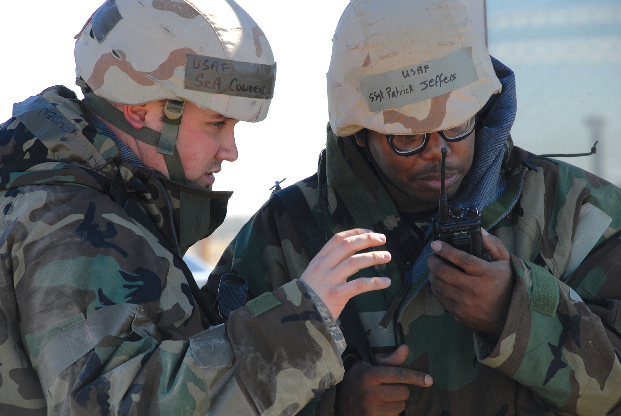 Senior Airman Ryan Cowden, 56th Security Forces Squadron, and Staff Sgt. Patrick Jeffers, 56th Maintenance Operations Squadron, discuss procedures for describing a vehicle trying to gain access to the exercise play area while participating in Ability to Survive and Operate training during Exercise Crown Talon 08-04 Nov. 18. (photo by Airman 1st Class Tracie Forte)