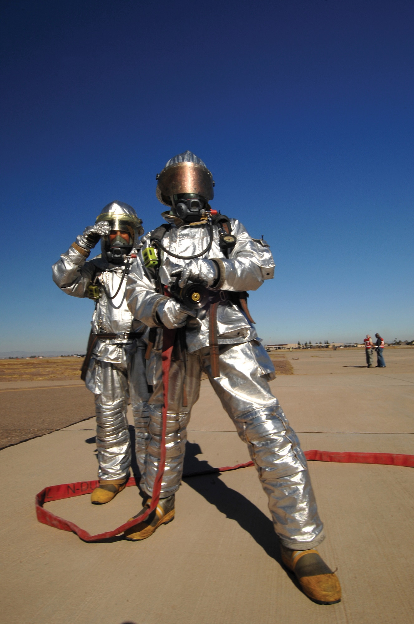 Staff Sgts. Michael Brick and Drew Jeffries, 56th Civil Engineer Squadron firefighters, stand at the ready during a simulated flightline emergency during Exercise Crown Talon. (photo by Tech. Sgt. Jeffrey Wolfe)