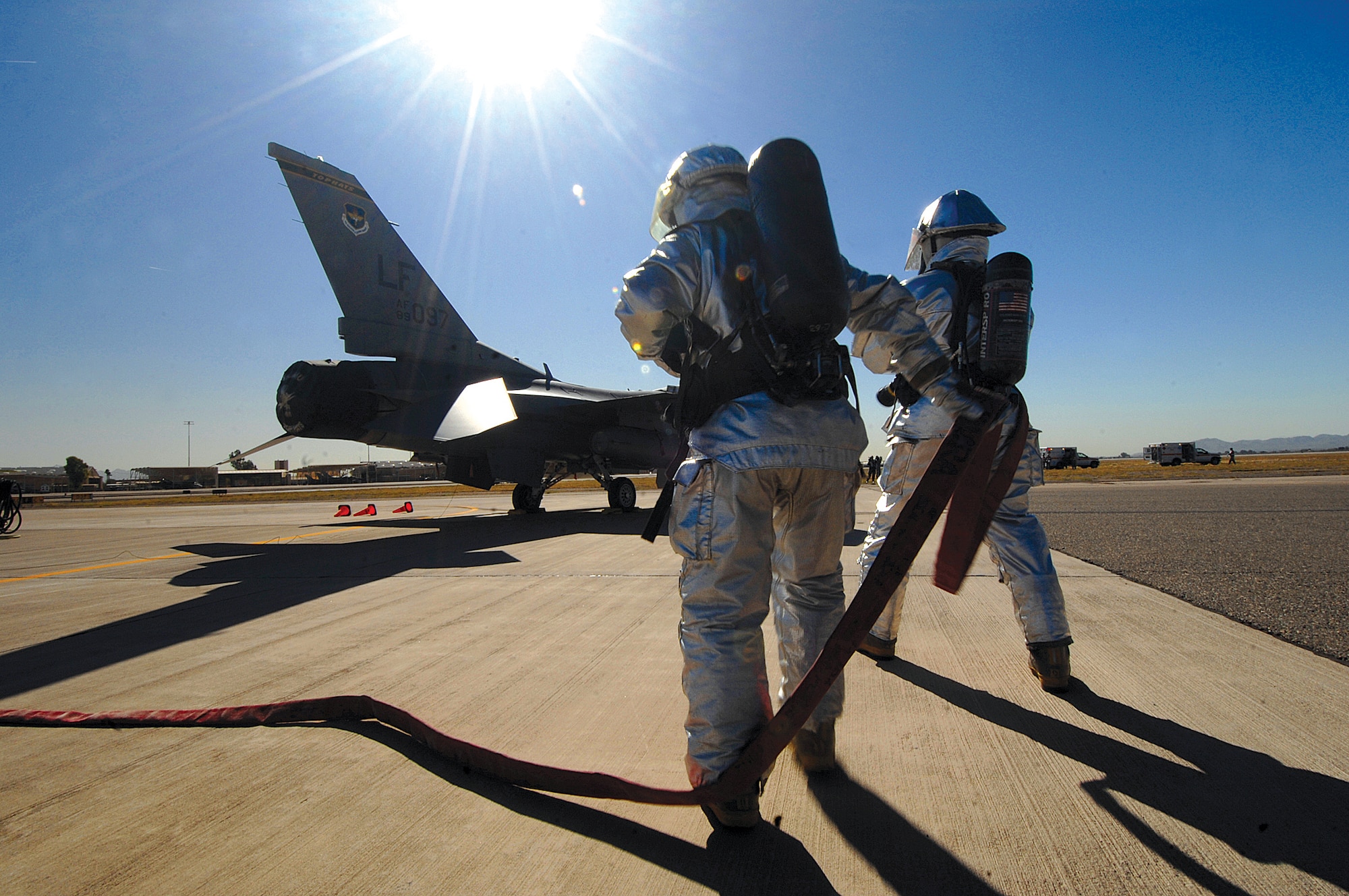 Firefighters Staff Sgts. Michael Brick and Drew Jeffries move into position during a simulated flightline emergency as part of Exercise Crown Talon 04-08. (photo by Tech. Sgt. Jeffrey Wolfe)