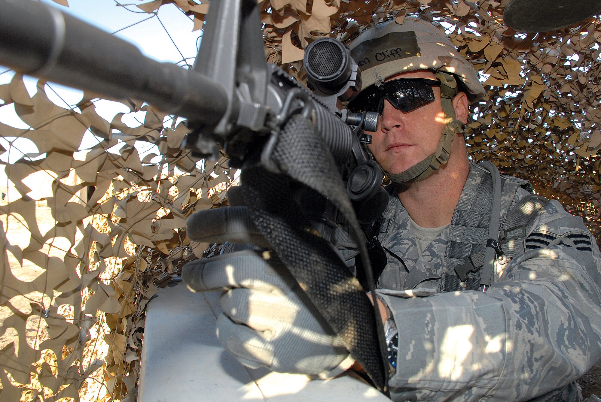 Staff Sgt. Clifford Dixon, 56th Security Forces Squadron, watches for terrorist activity outside the front gate of the exercise play area while participating in Exercise Crown Talon 04-08 Nov. 18. (photo by Airman 1st Class Tracie Forte)