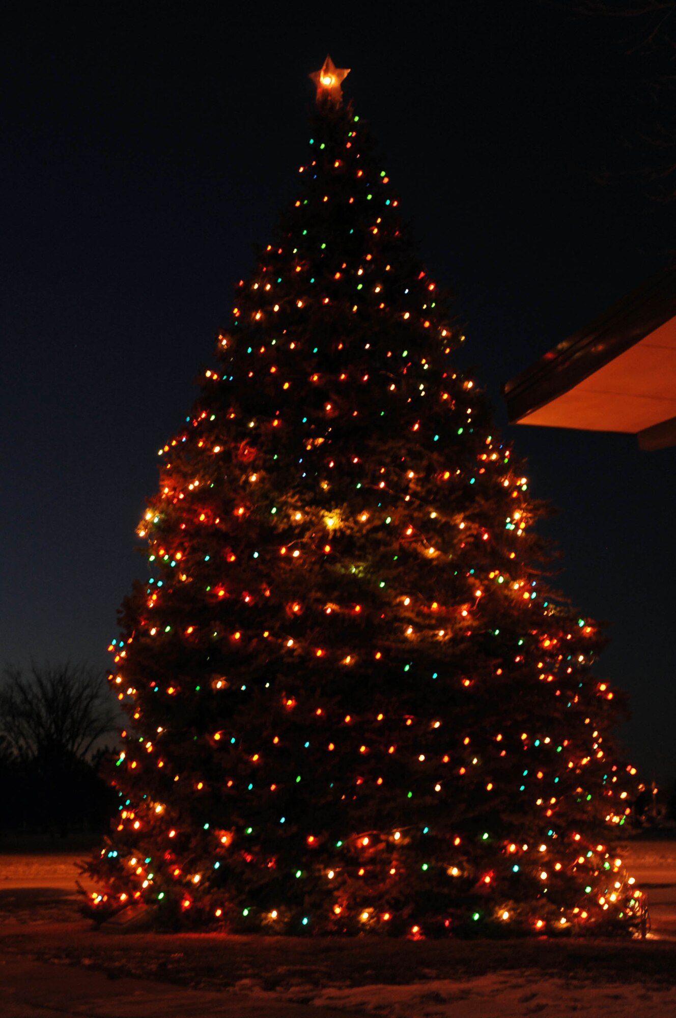 The annual holiday tree lighting, sponsored by the Freedom Chapel, was celebrated here, Dec. 4. Many Airmen and their families stood in the bitter cold to watch the holiday tree light up. (U.S. Air Force photo by Airman 1st Class Joshua J. Seybert)