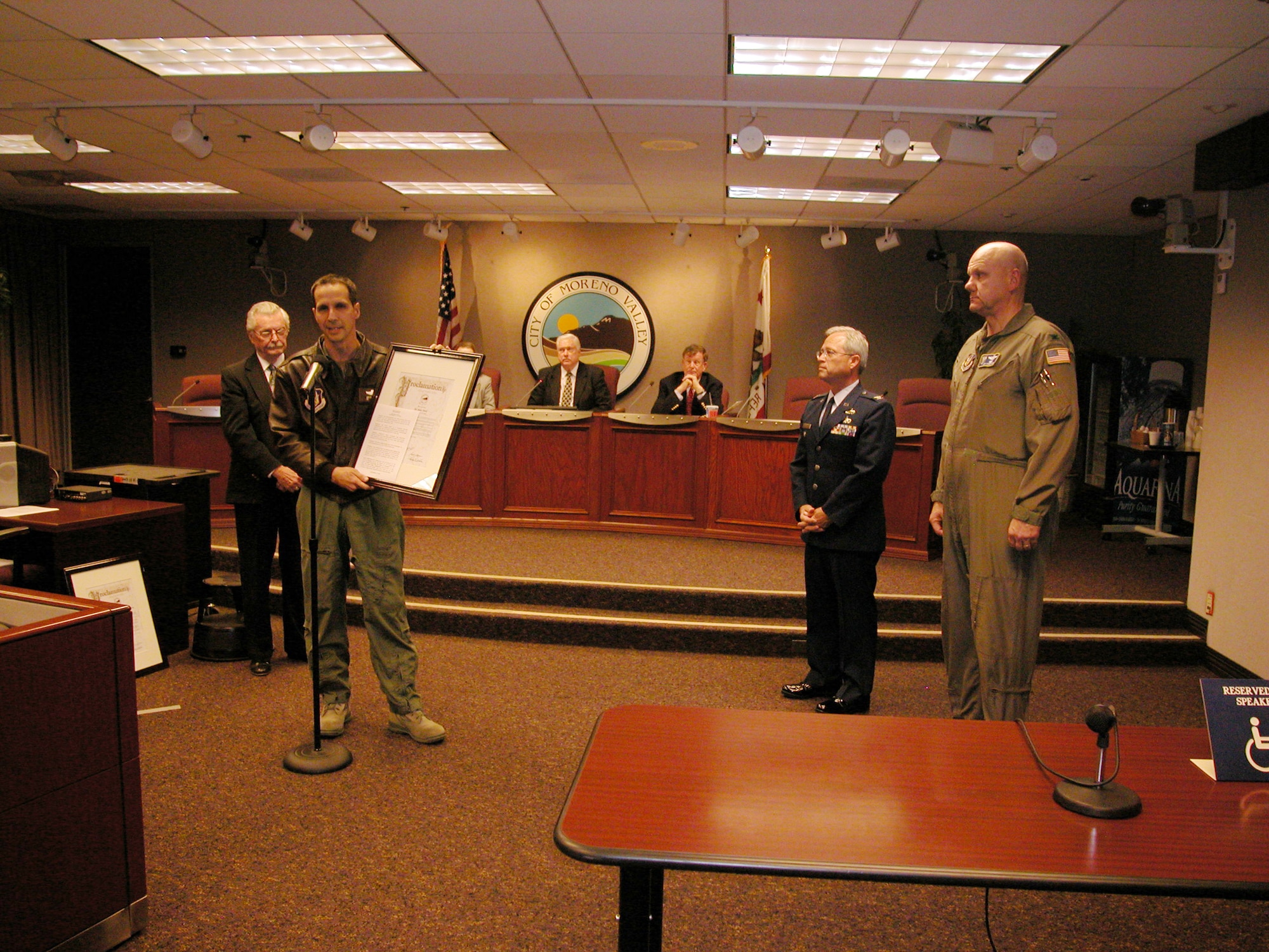 Col. Jeff Pennington, 452 Operations Group commander, holds the AF Week proclamation given to him by Moreno Valley City Councilmember Charles White (left) during a recent City Council meeting. Col. Bruce Stewart, 163 RW vice commander (second from right) and Col. Jeff Robertson, 4th AF director of staff, were also present to accept the proclamation and thank the City Council and the citizens of Moreno Valley for their support. (U.S. Air Force photo by Maj. Don Traud)