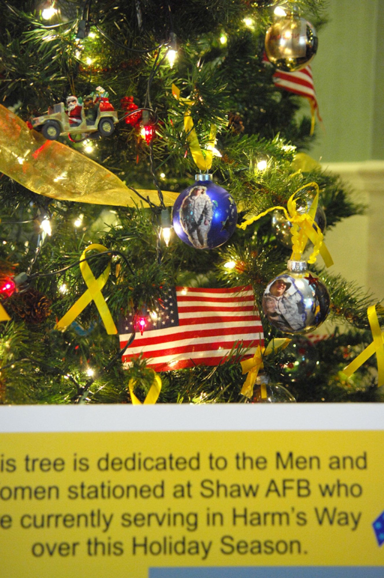 SHAW AIR FORCE BASE, S.C. -- Family members honor deployed loved ones by placing photos and homemade ornaments on the Deployed Family Christmas Tree. The tree is on display at the Carolina Skies Club. (U.S. Air Force photo/Staff Sgt. Patrick Mitchell)  