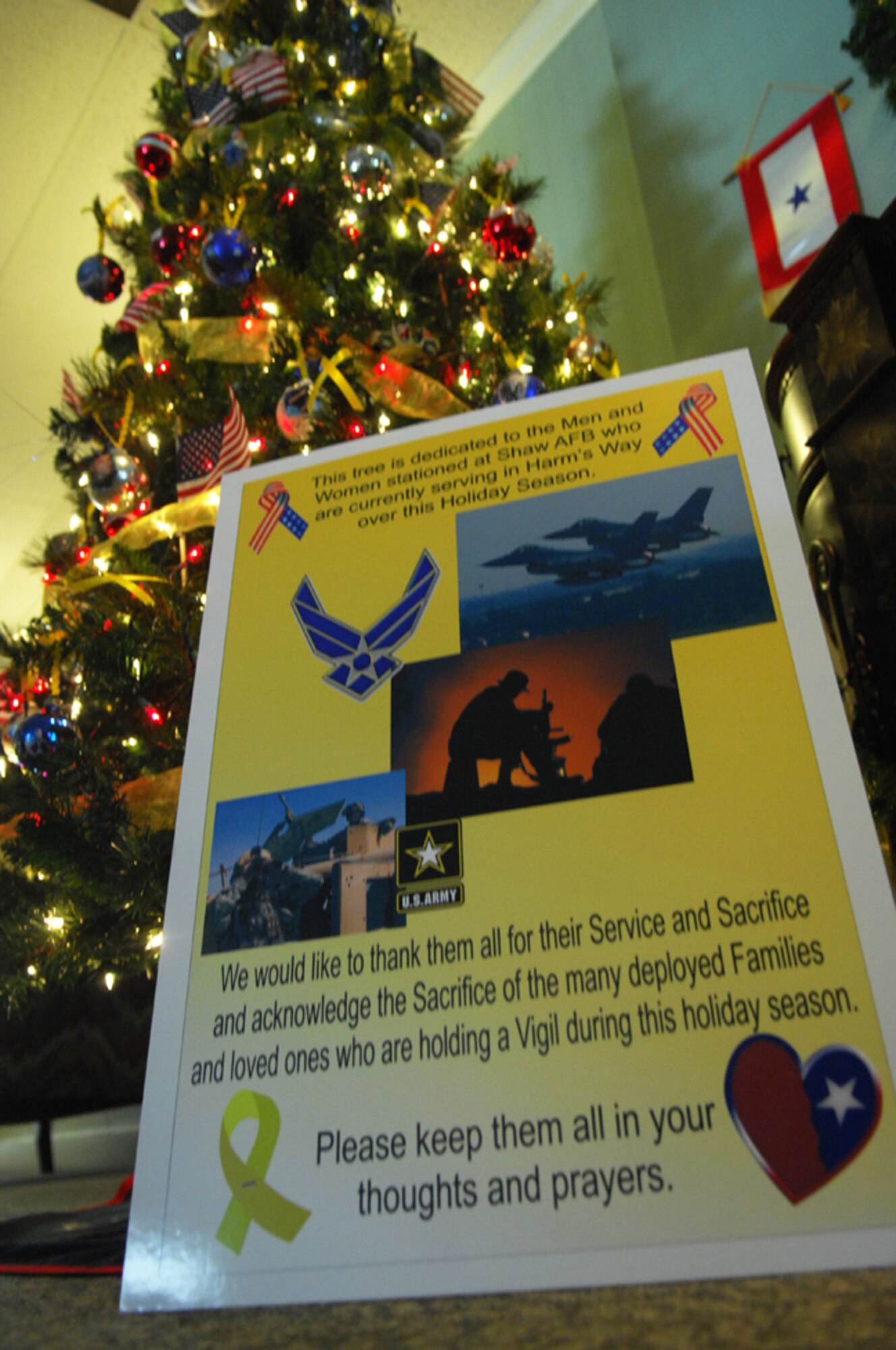 SHAW AIR FORCE BASE, S.C. -- Family members honor deployed loved ones by placing photos and homemade ornaments on the Deployed Family Christmas Tree. The tree is on display at the Carolina Skies Club. (U.S. Air Force photo/Staff Sgt. Patrick Mitchell)  
