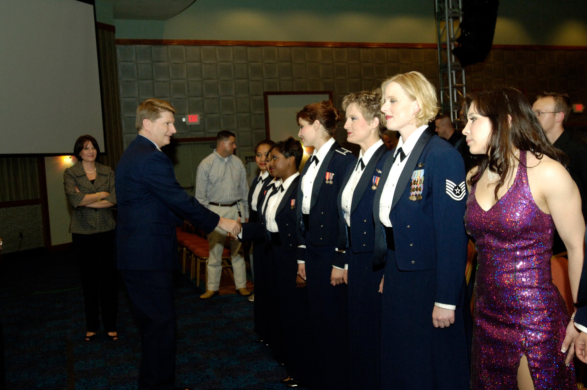 FAIRCHILD AIR FORCE BASE, Wash. – Col. Robert Thomas, 92nd Air Refueling Wing commander, coins members of the Air Force Tops in Blue after their performance at Northern Quest Casino Dec 1. Tops in Blue performers travel to Air Force bases around the globe to entertain and aid in recruiting efforts. (U.S. Air Force photo / Senior Airman Eunique Stevens)